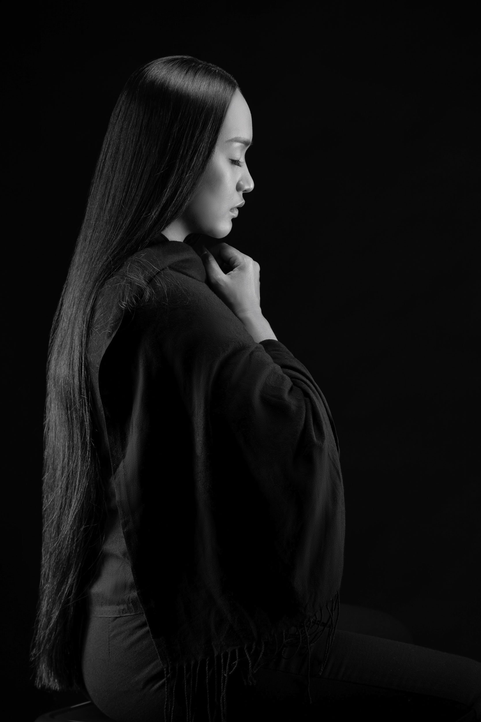 Studio portrait of woman with minimalist lighting photographed for fashion and editorial photography.
