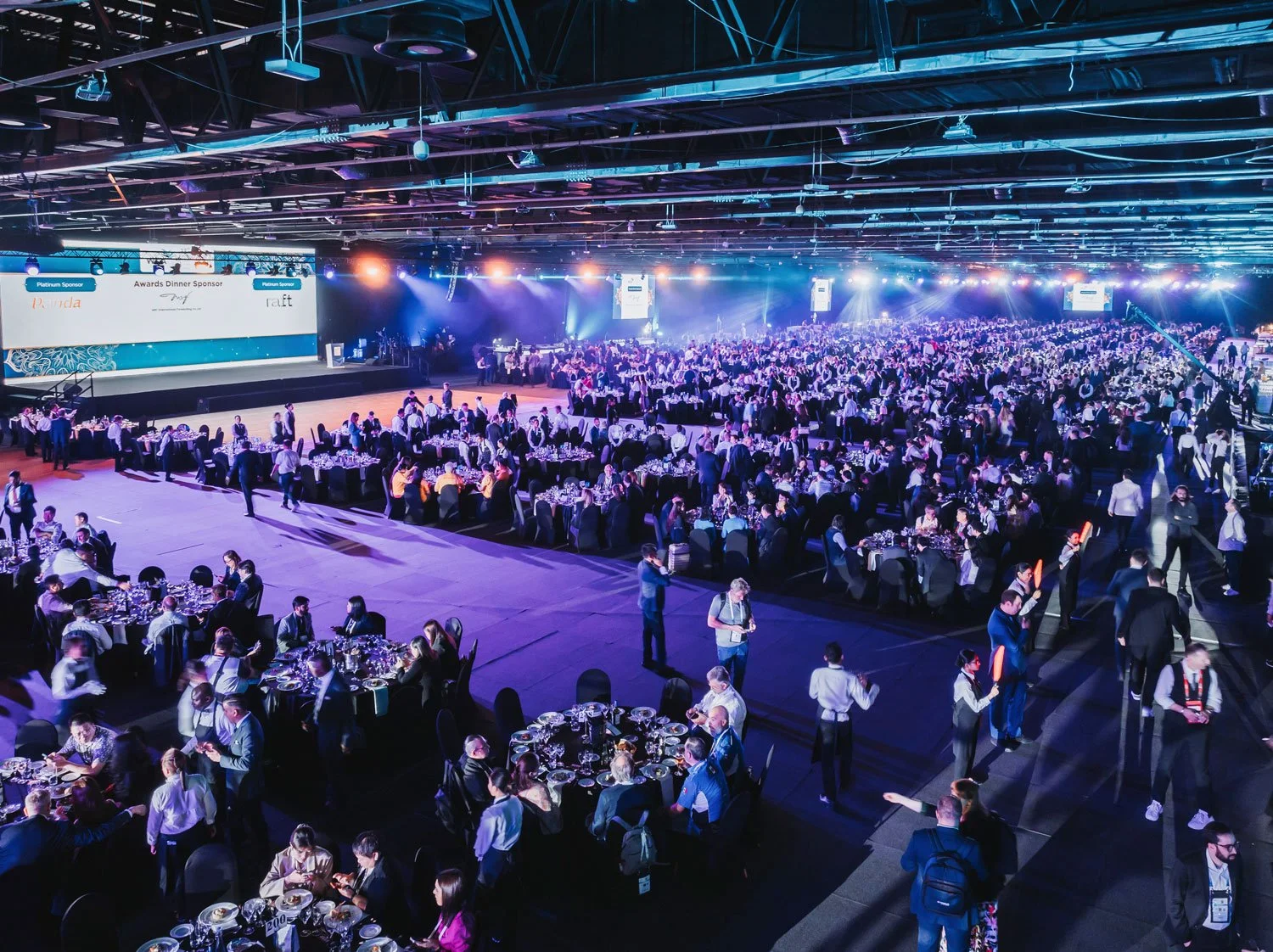 Corporate awards gala with stage entertainment and audience seating.