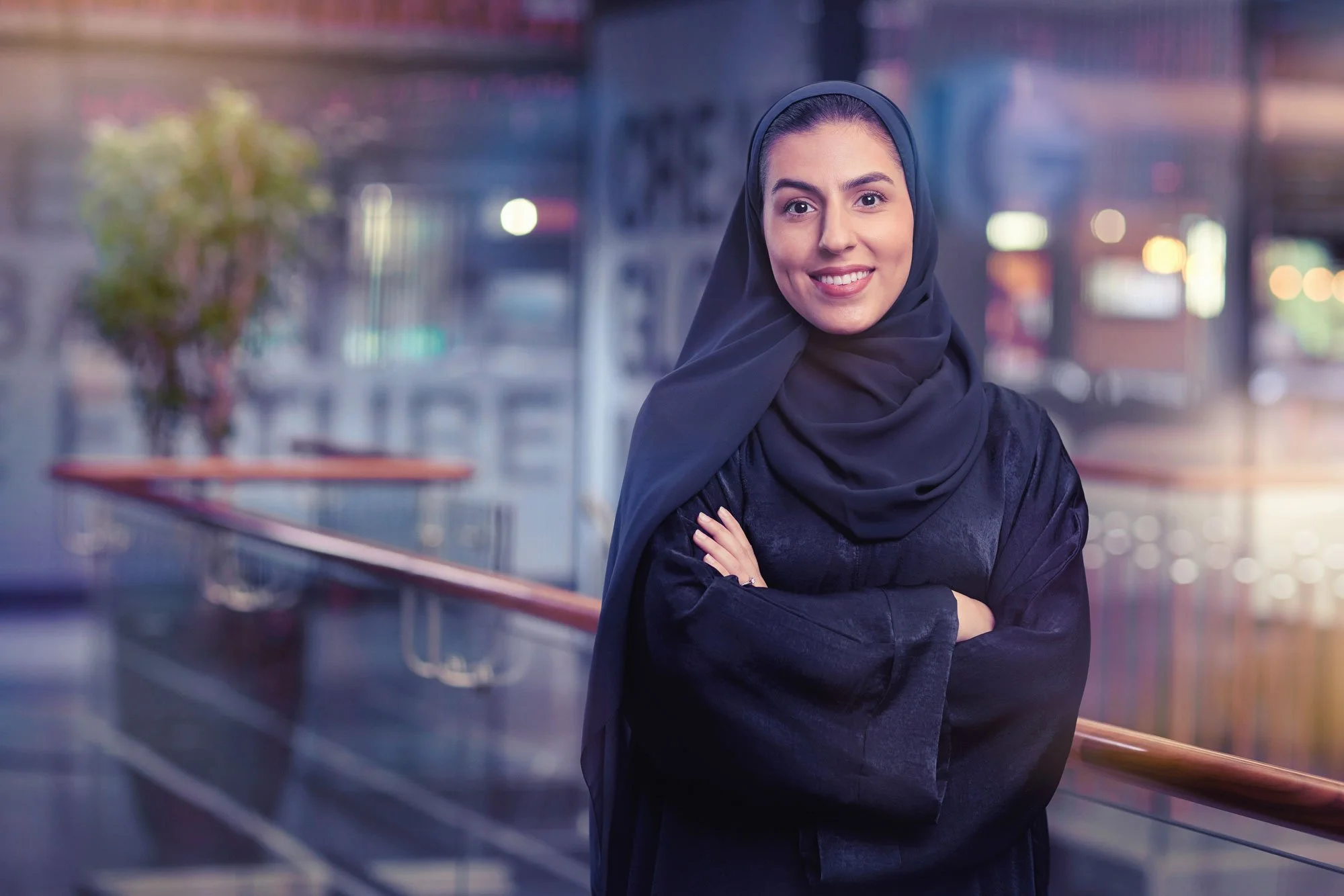 Business portrait photographed in office with city skyline background in Dubai.