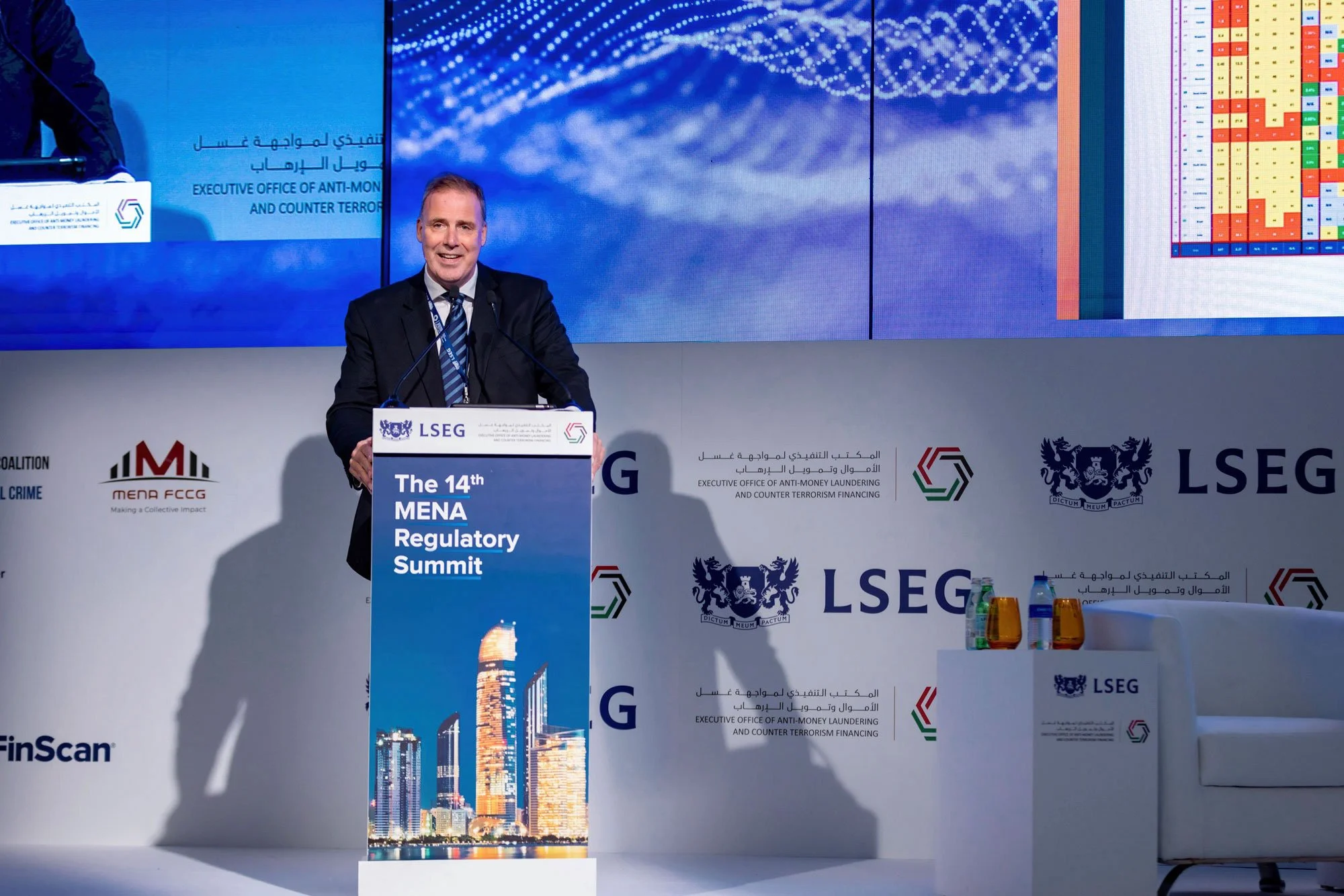 Executive speaker presenting during international business summit.