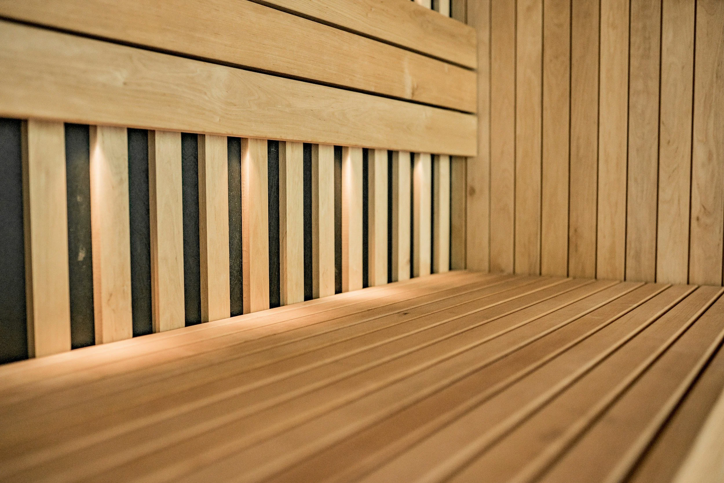 Wooden slatted interior with vertical and horizontal wooden panels.