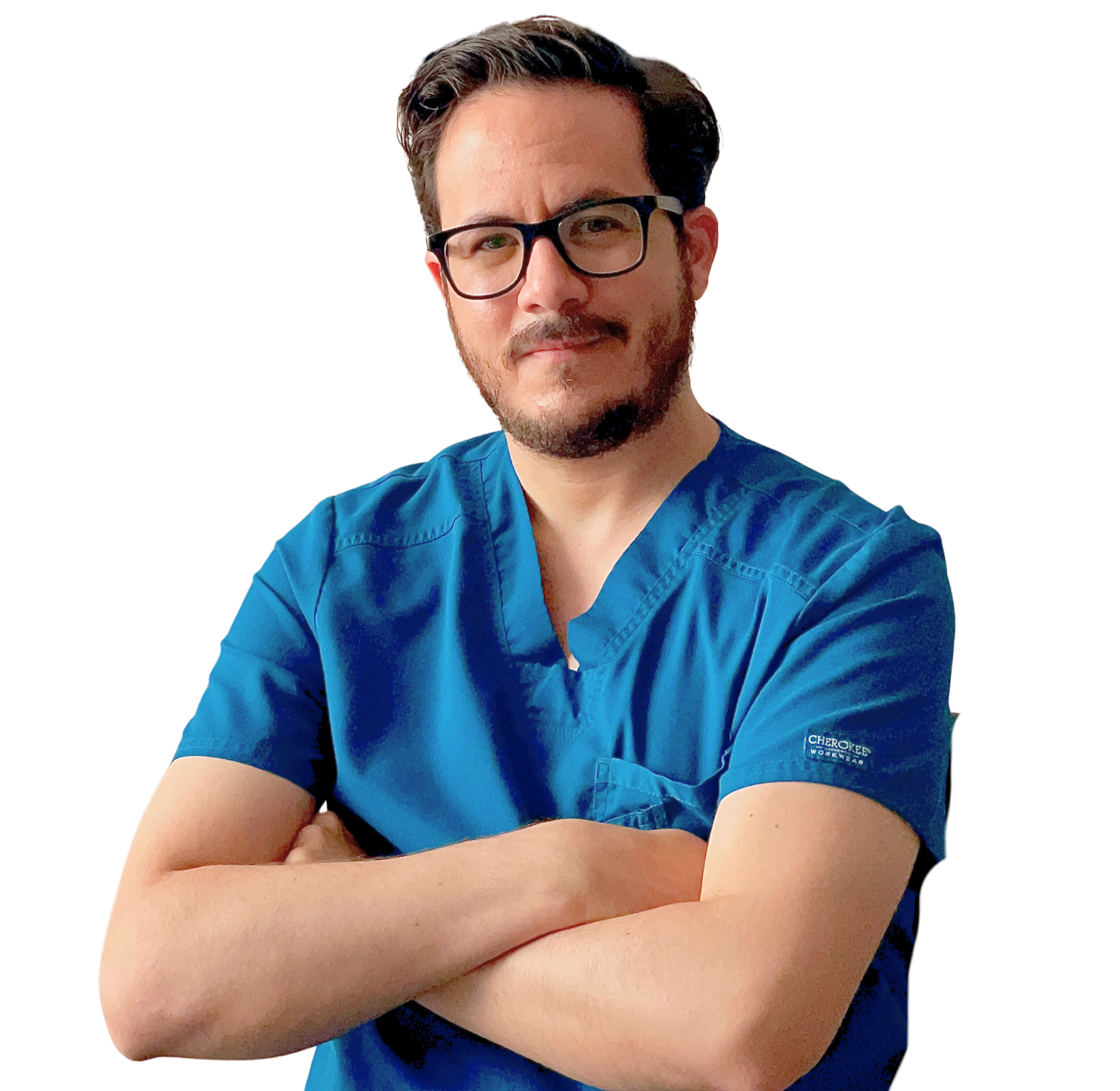 A man wearing blue scrubs with arms crossed, glasses, and a slight smile.