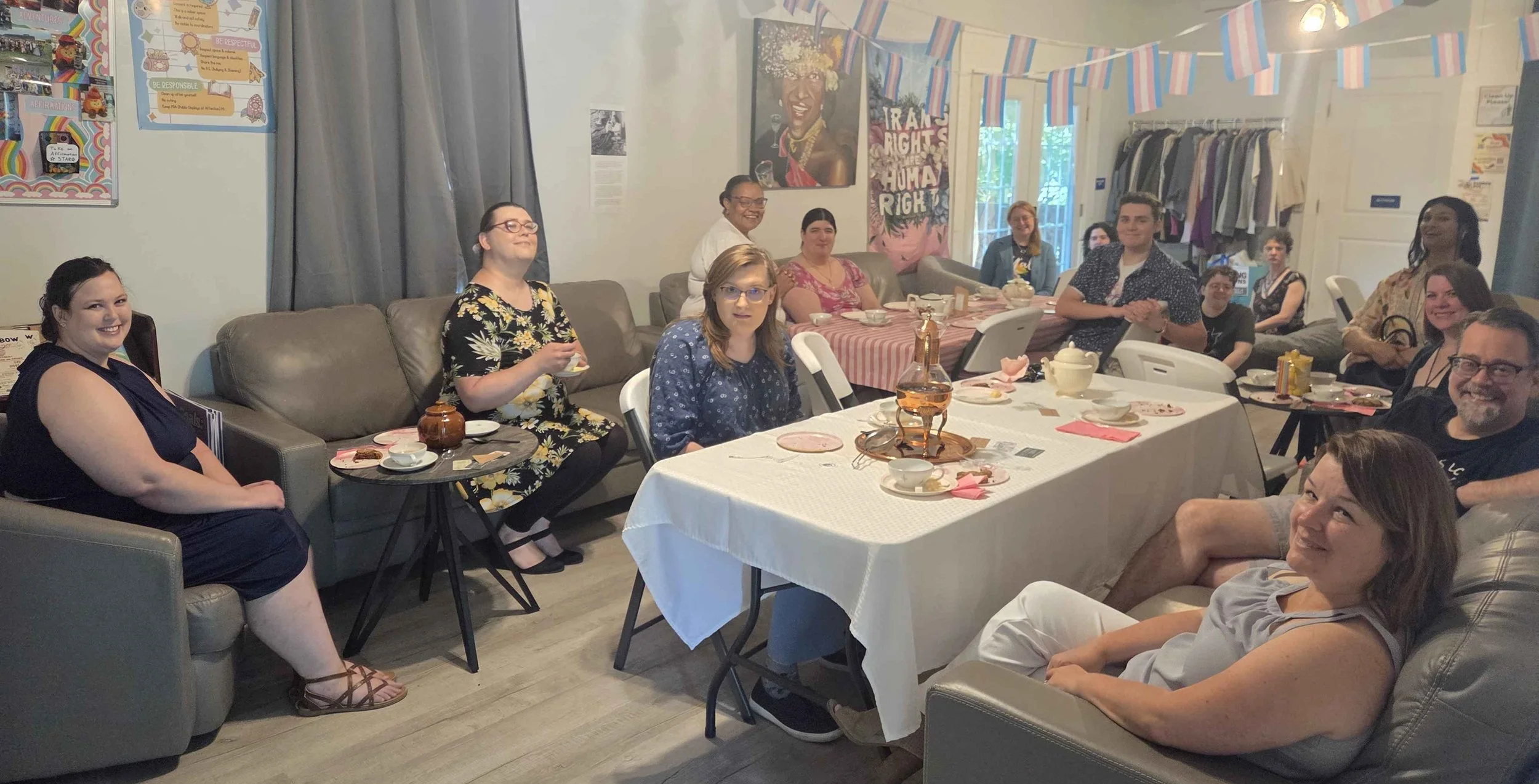 Attendees of the SolidariTEA drinking tea and smiling. 