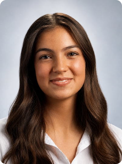 Portrait of a young woman with long brown hair, smiling, wearing a white shirt, against a light blue background.