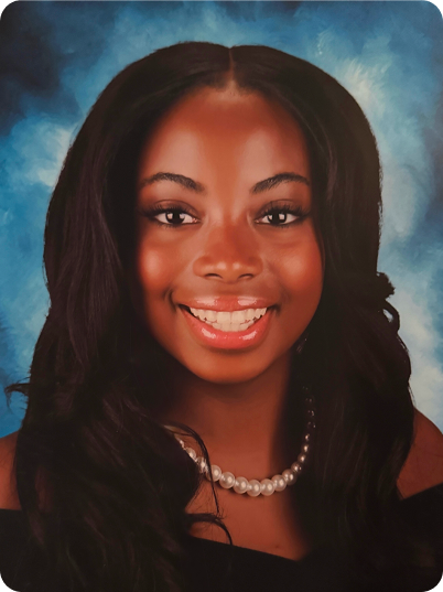 A young woman with long dark hair, smiling, wearing a pearl necklace, against a blue background.