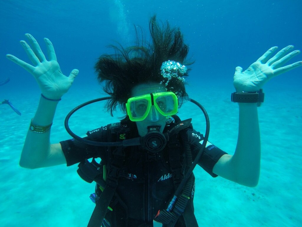 Woman scuba diving with hair in disarray, illustrating Sunday Scaries anxiety