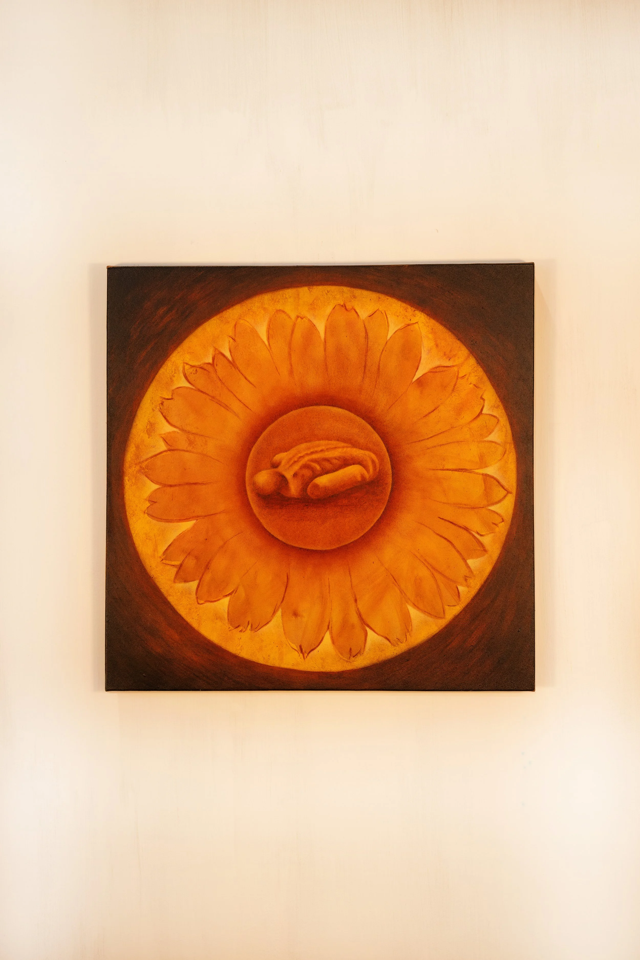 Painting of a yellow flower with a central medallion showing a curled banana, on a dark background.