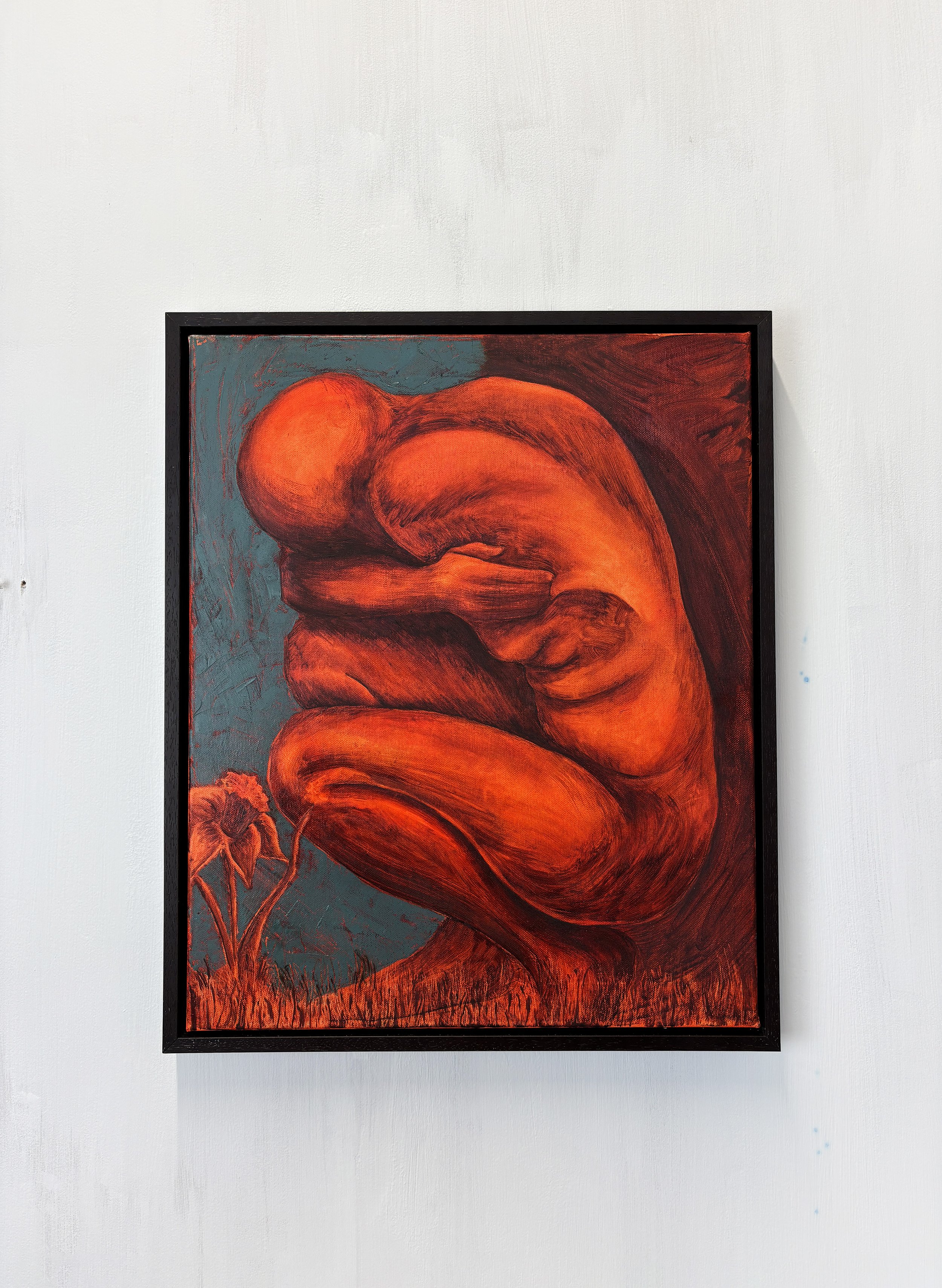 Painting of a curled-up nude figure in red and orange tones, with a blue background and a flower in the lower left corner.