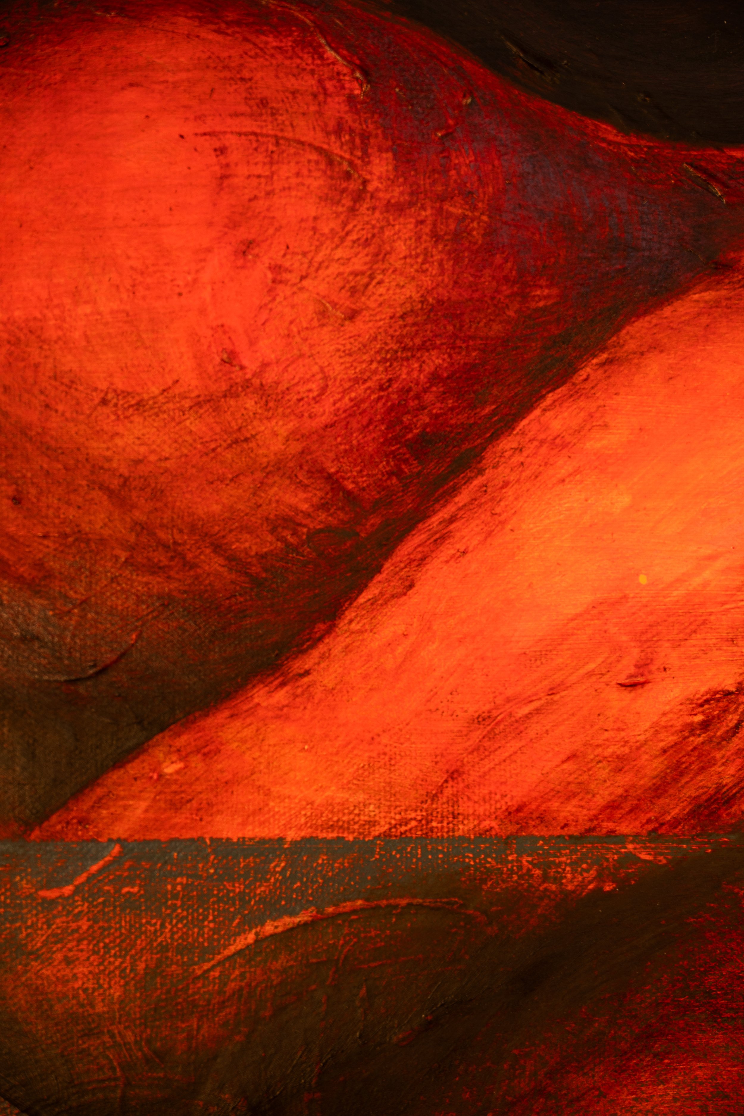Close-up view of abstract textured red and black painted surface with visible brush strokes.