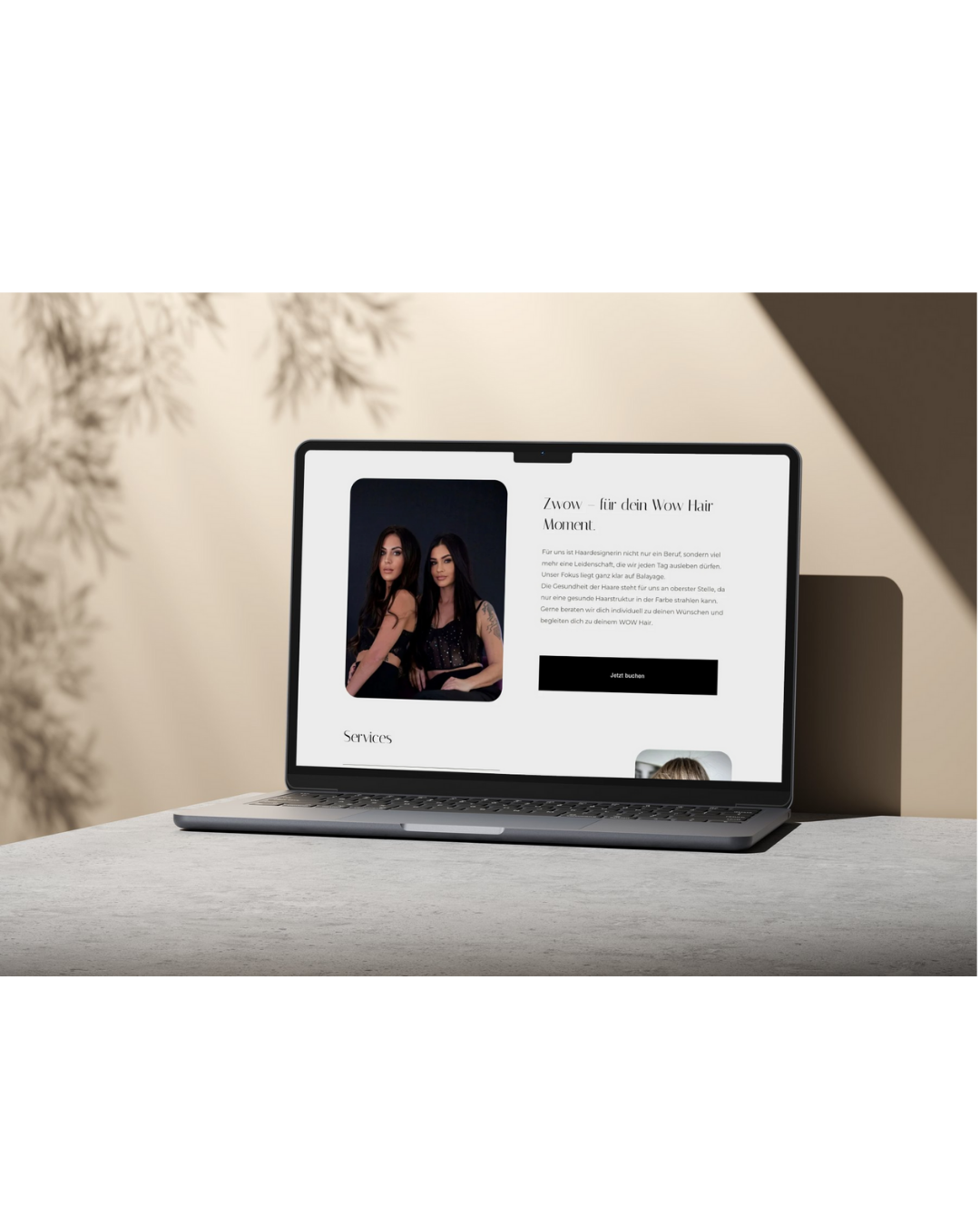 Laptop auf einem Tisch mit einer Webseite, die Werbung für Haarstyling-Services zeigt, mit einem Bild von zwei Frauen mit langen dunklen Haaren, im Hintergrund ein beige-heller Raum mit Pflanzen.