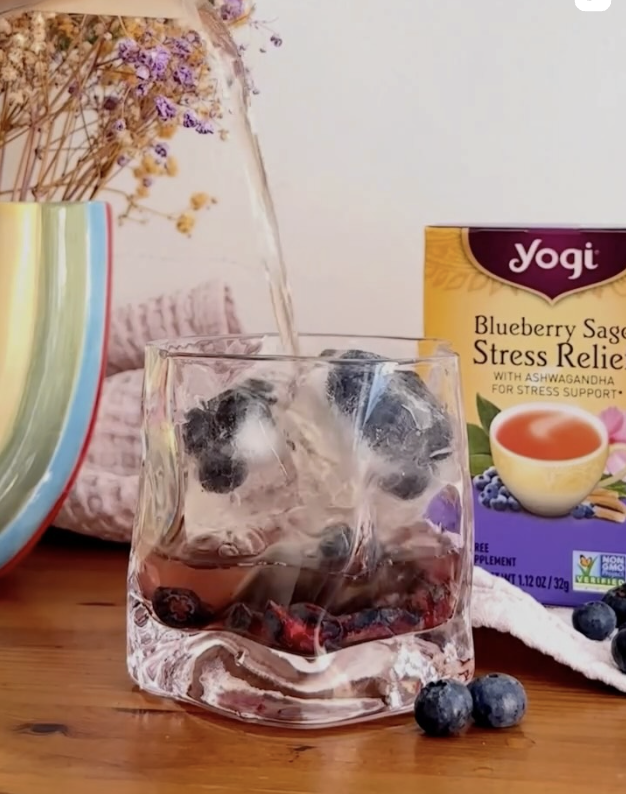a glass of iced Yogi blueberry stress relief tea