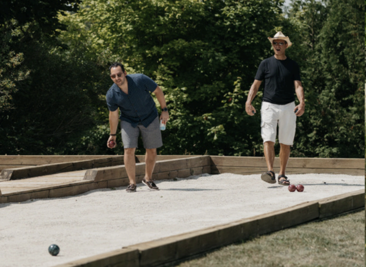 two men playing lawn bowling outside