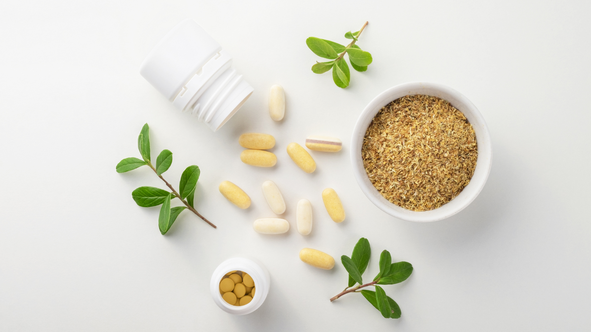 supplements, leaves, and powder spread out on a table