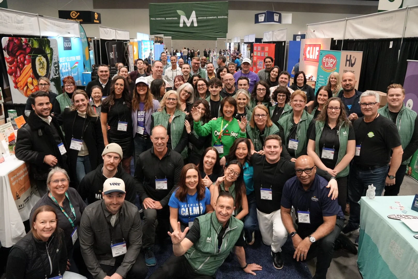 a large group of the Marsham team smiling and posing together at a convention
