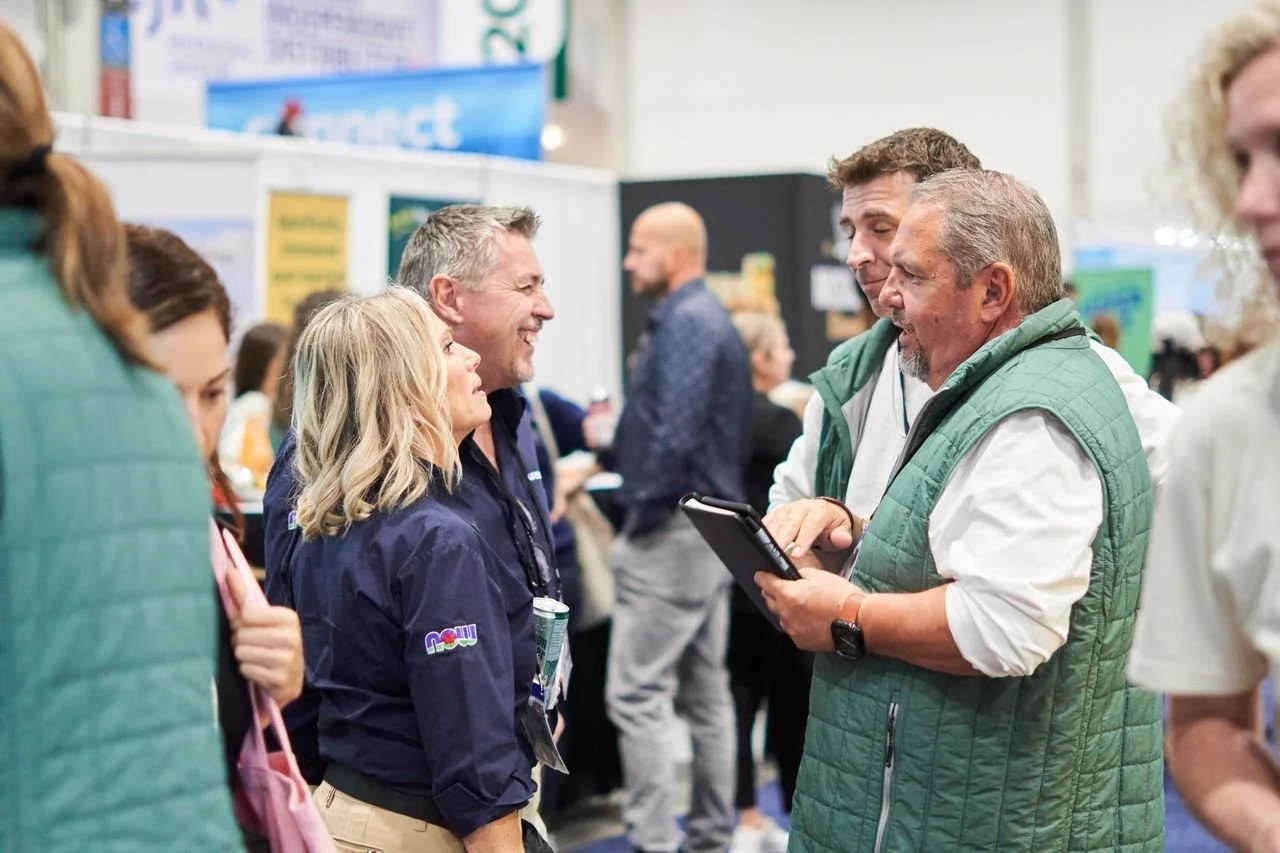 a group of people conversing at a convention