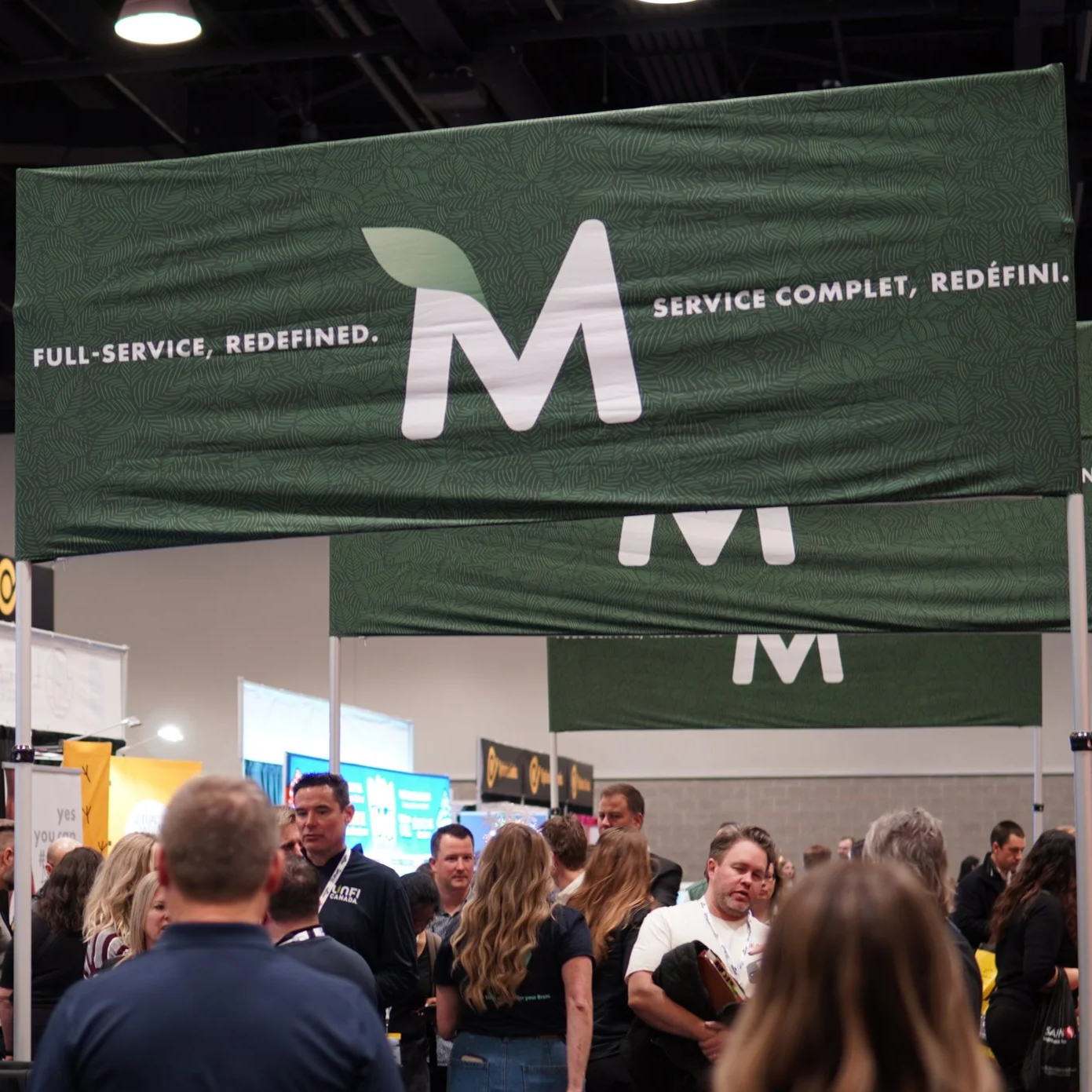 a Marsham banner at a convention with people walking underneath