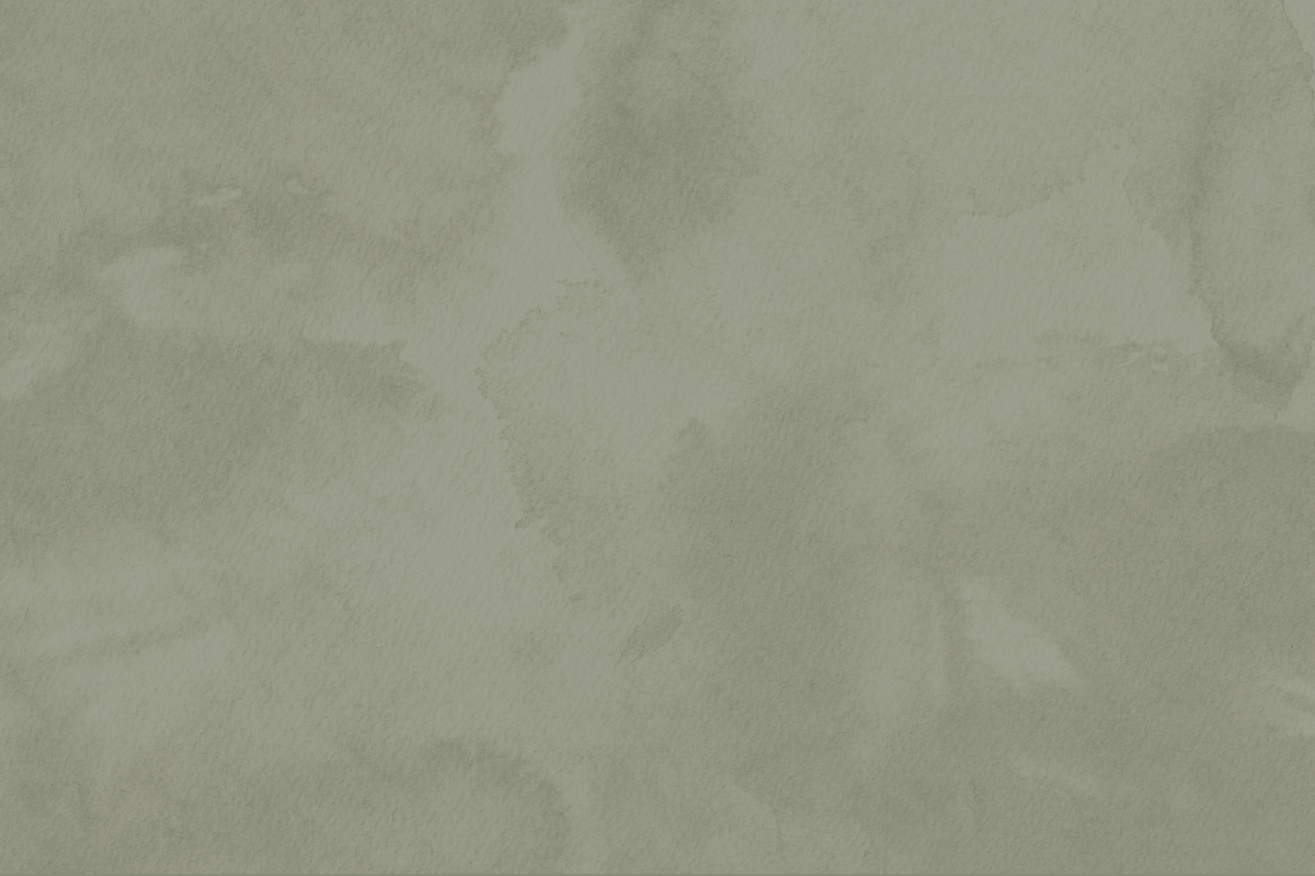 A close-up of a textured, light green watercolor paper background.