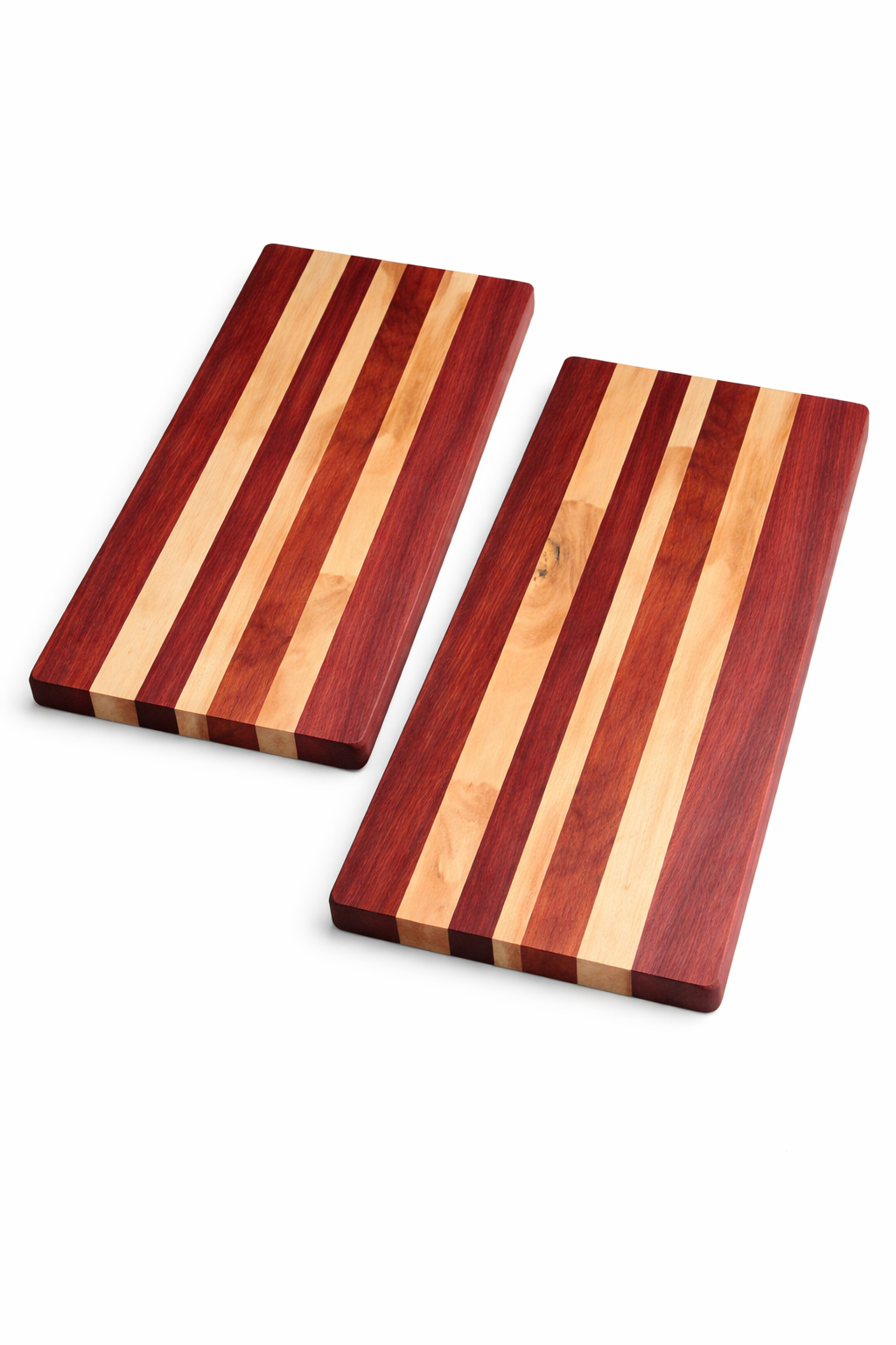 Two wooden long grain cutting boards with striped patterns in Padauk and Maple.