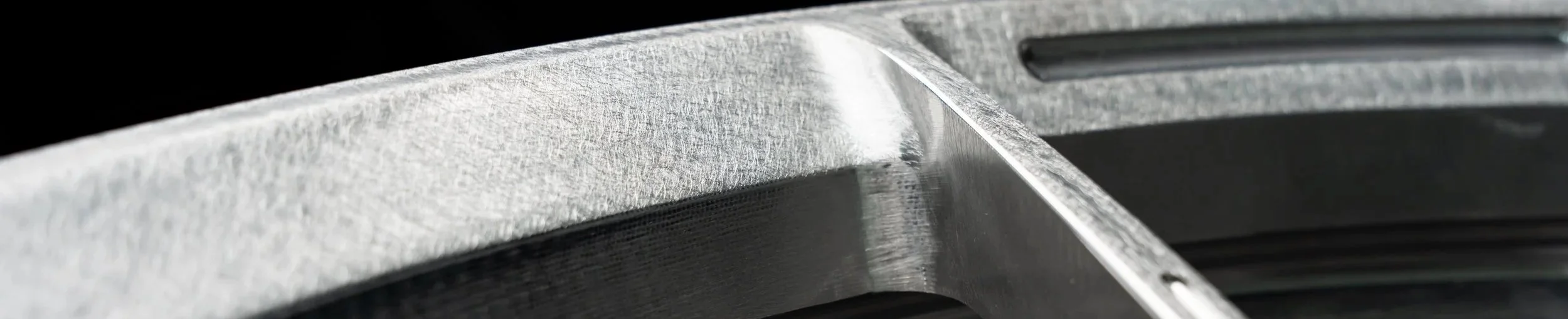 Close-up of a metallic surface with textured and smooth areas