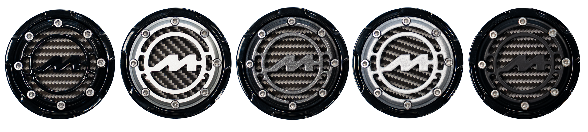 Five circular motorcycle gas caps with different black, silver, and carbon fiber designs and logo symbols in the center.
