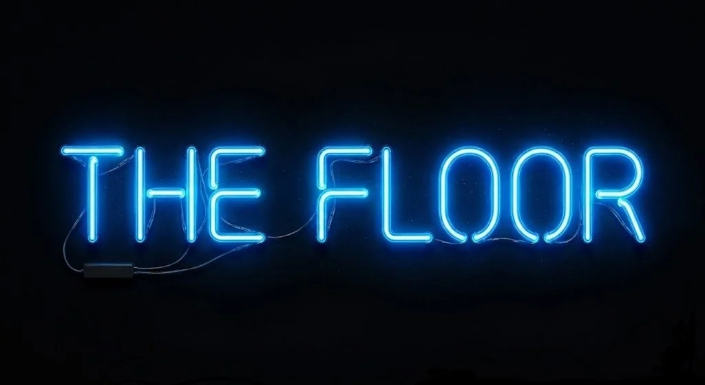 Blue neon sign that reads 'THE FLOOR' against a black background.