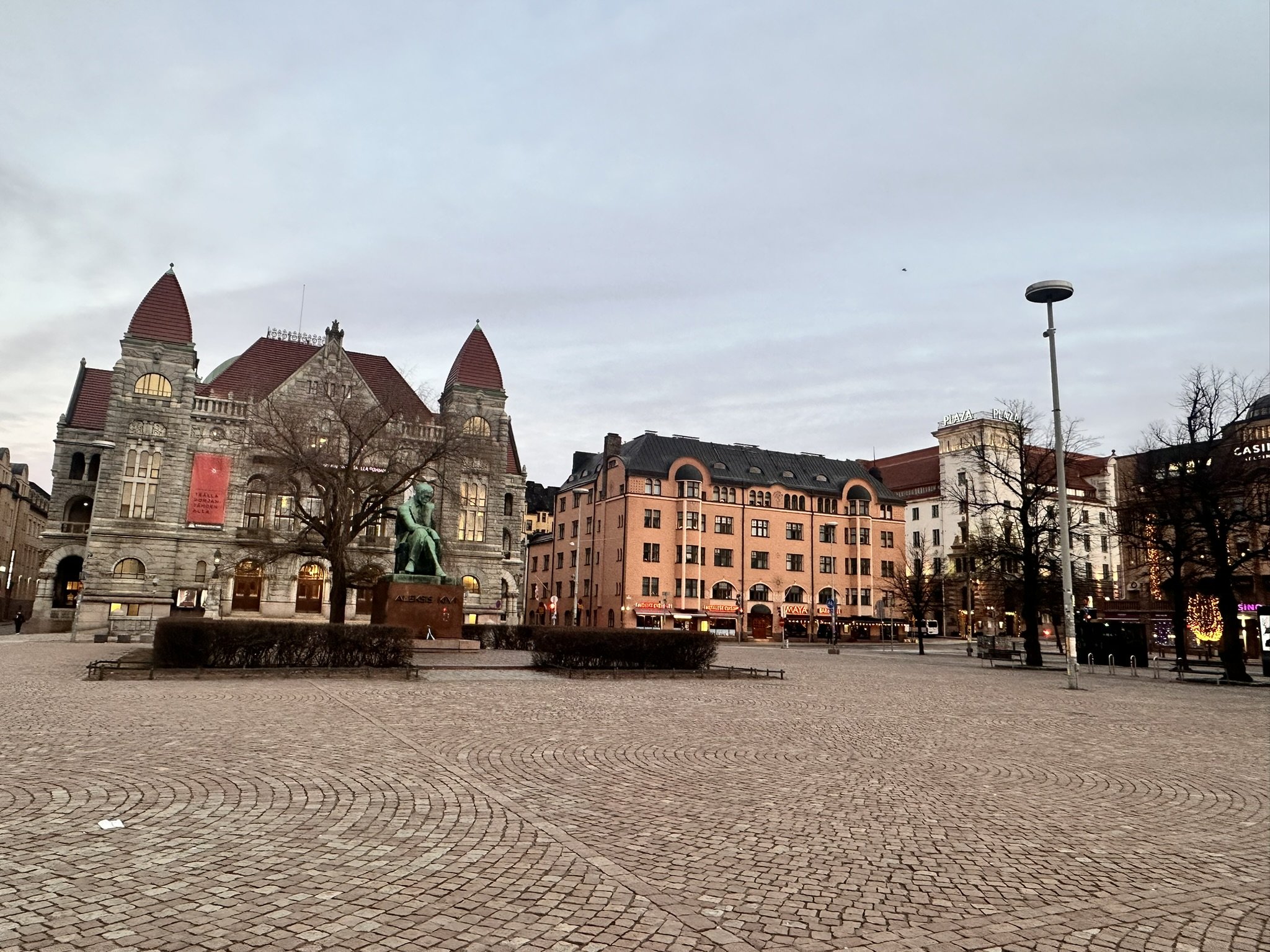 Helsinki Central Railway Station square with Christmas lights and green tram showing walkable city center location near Radisson Blu Plaza Hotel