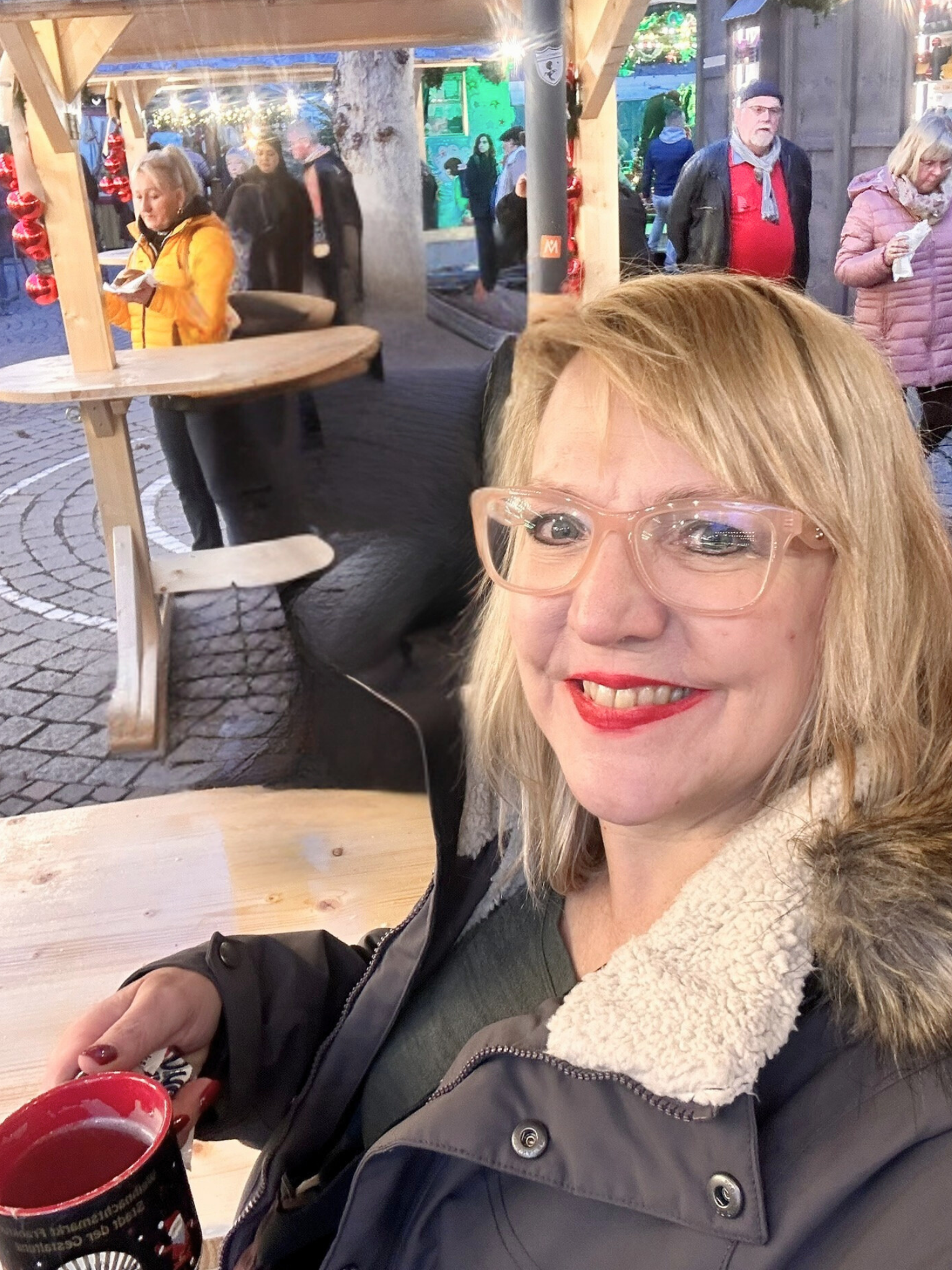 Woman drinking glühwein at Frankfurt Christmas market