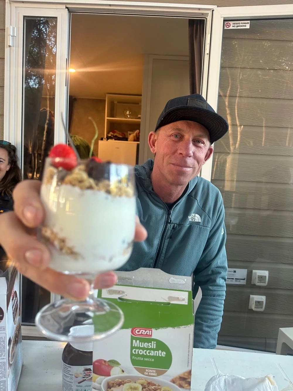 A man wearing a black cap and blue jacket