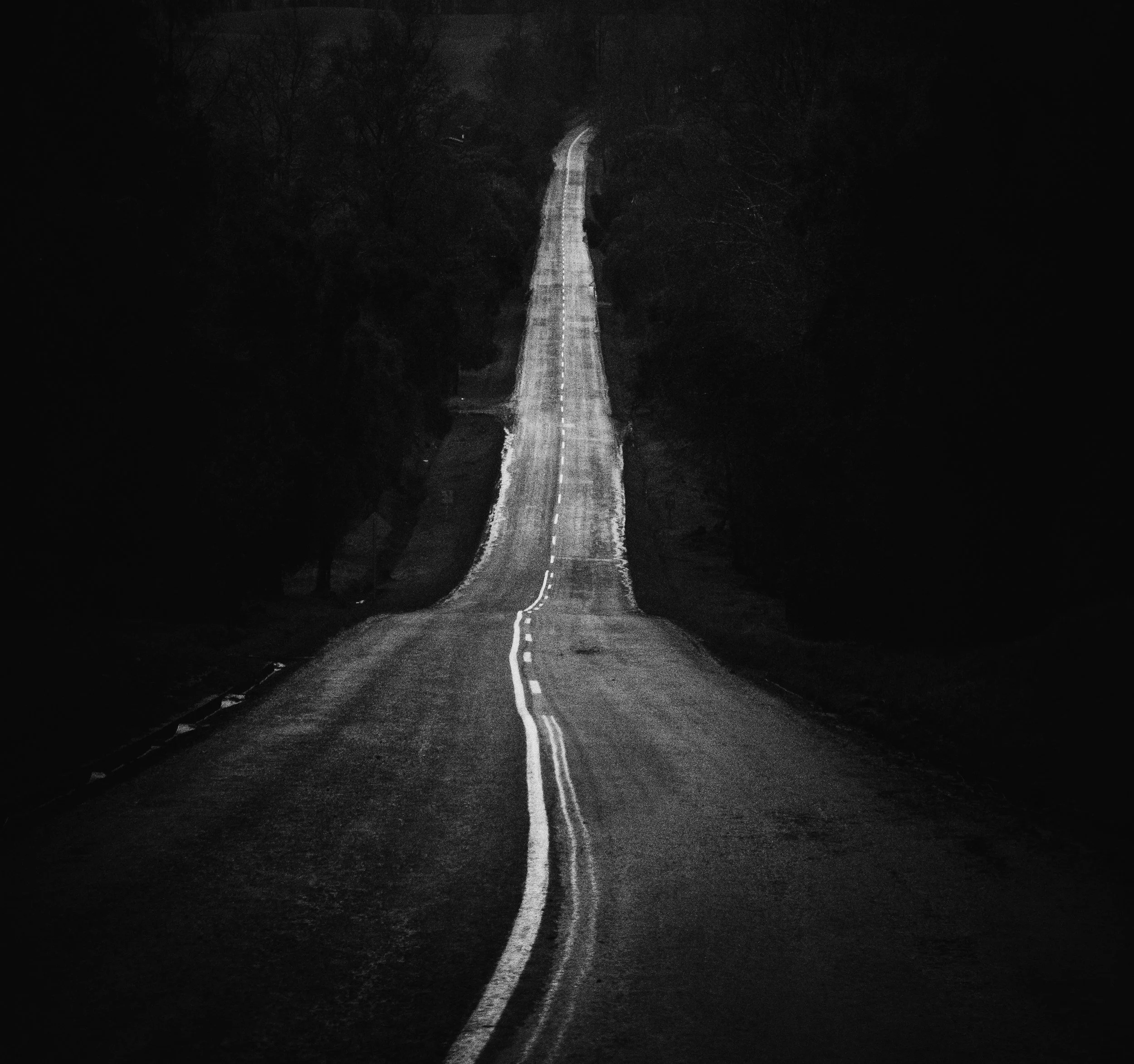 A dark winding road that depicts a real estate agent or broker's career path and the journey it takes to get to where they want to be.
