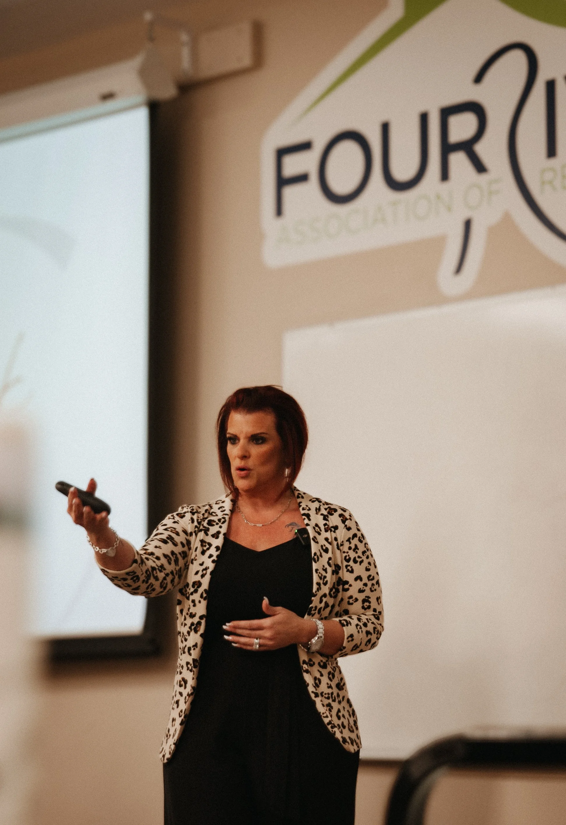 Amber Brown giving a presentation in front of a group of real estate agents at the Four Rivers Association of REALTORS®.