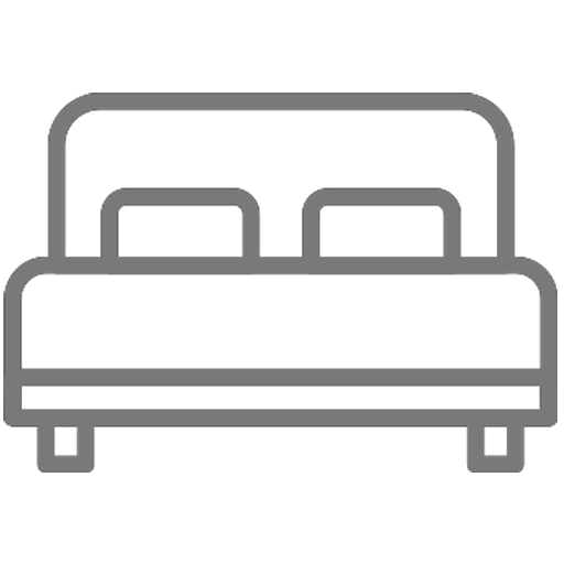 Silhouette of a bed with two pillows against a black background.
