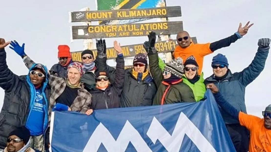 Celebrating at the top of Mount Kilimanjaro