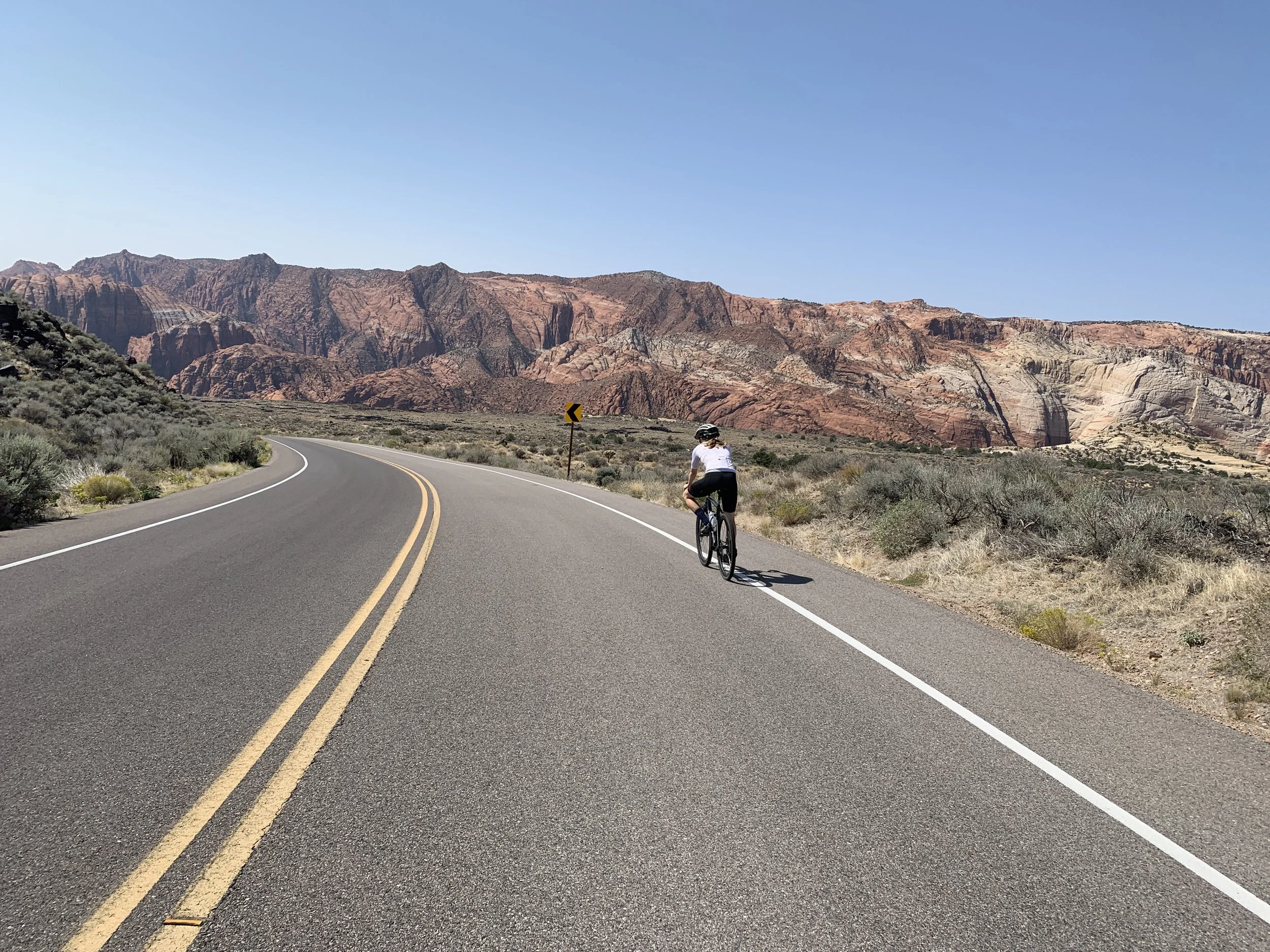 Clarice Sayle road biking in the desert of Moab, Utah.