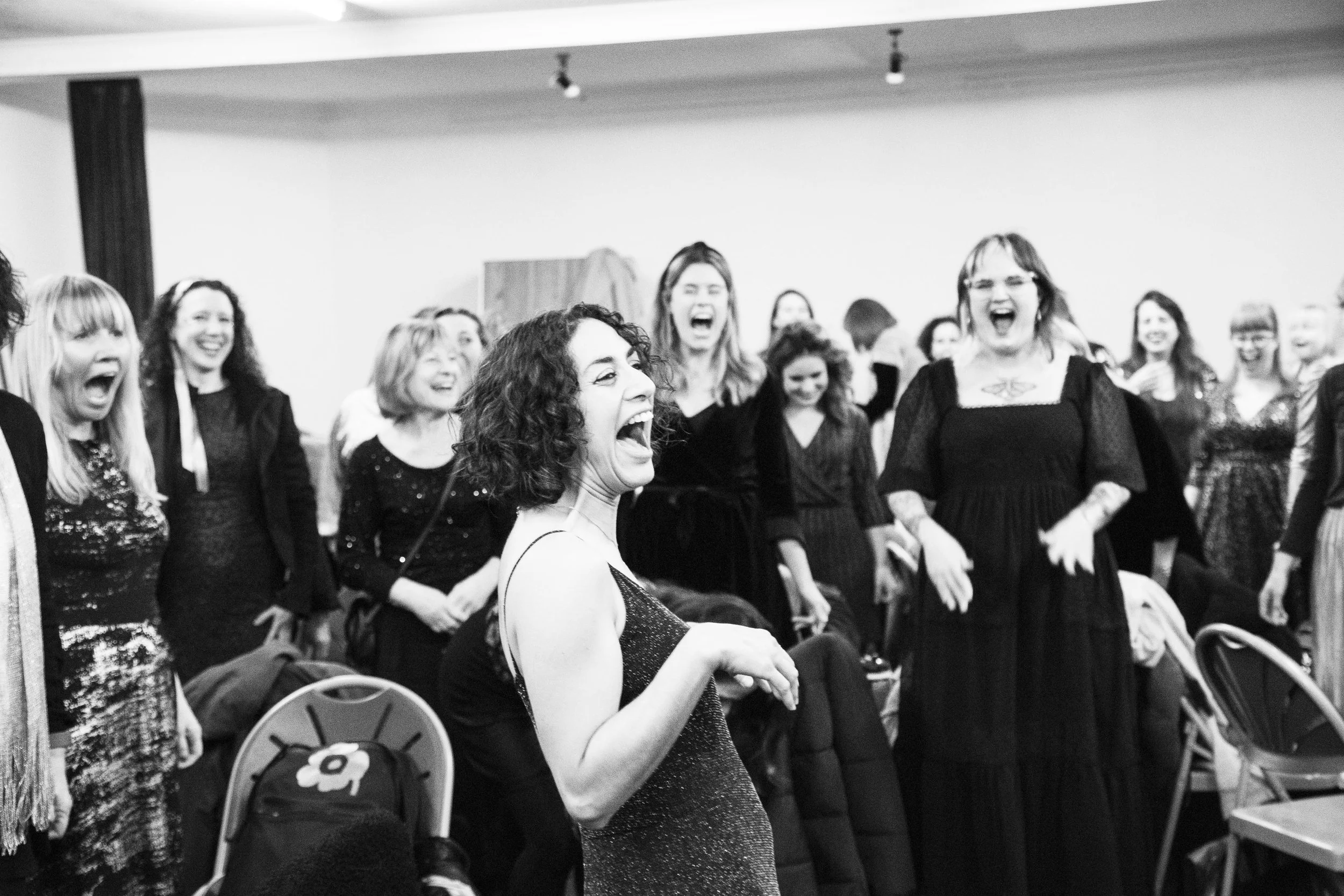 Choir leader Vanessa leading Soul of the City Choir through warm-ups just minutes before a gig.