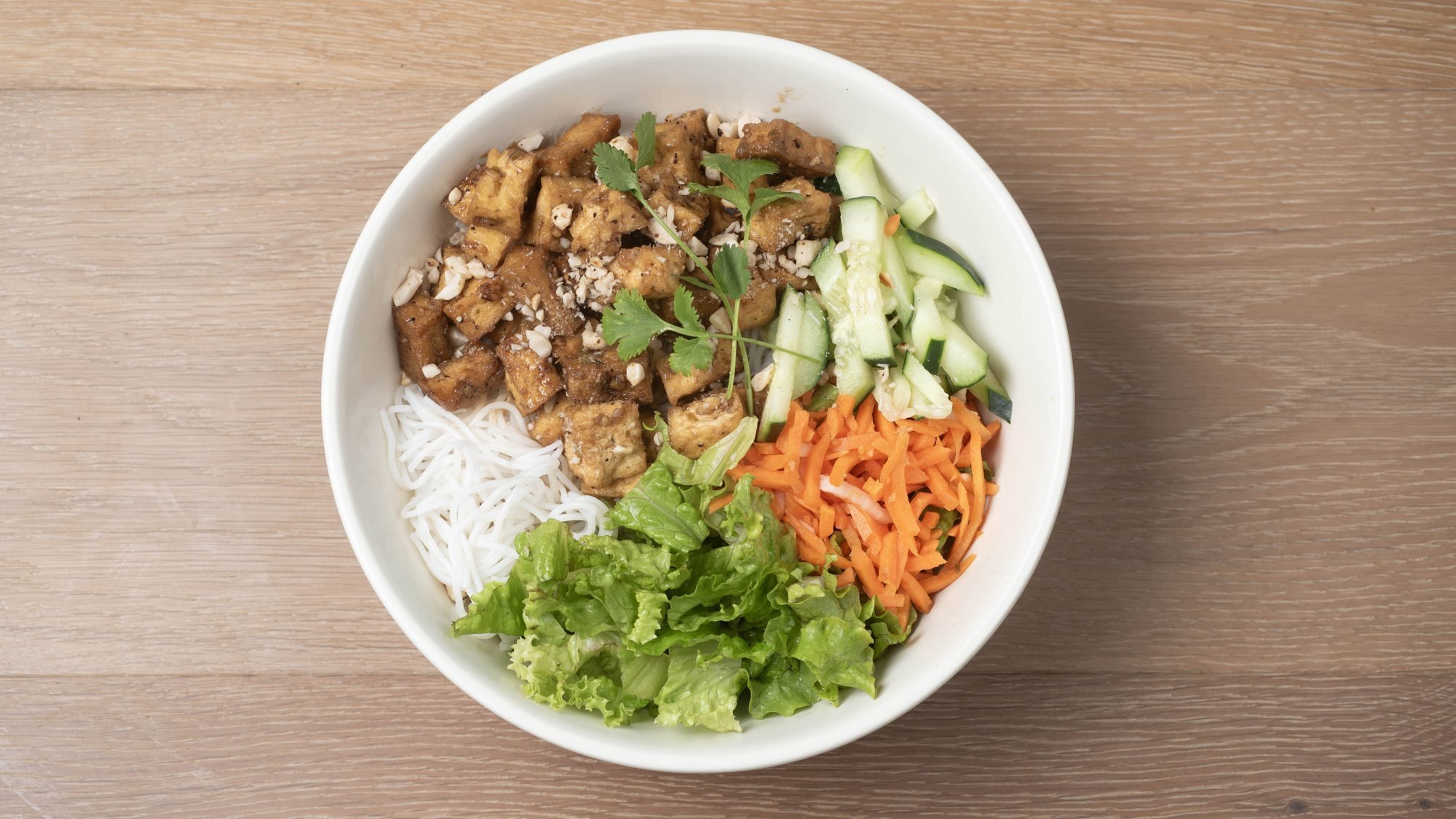 Tofu vermicelli bowl with rice noodles, lettuce, cucumber and pickled carrots at Noble Phở in Round Rock, TX