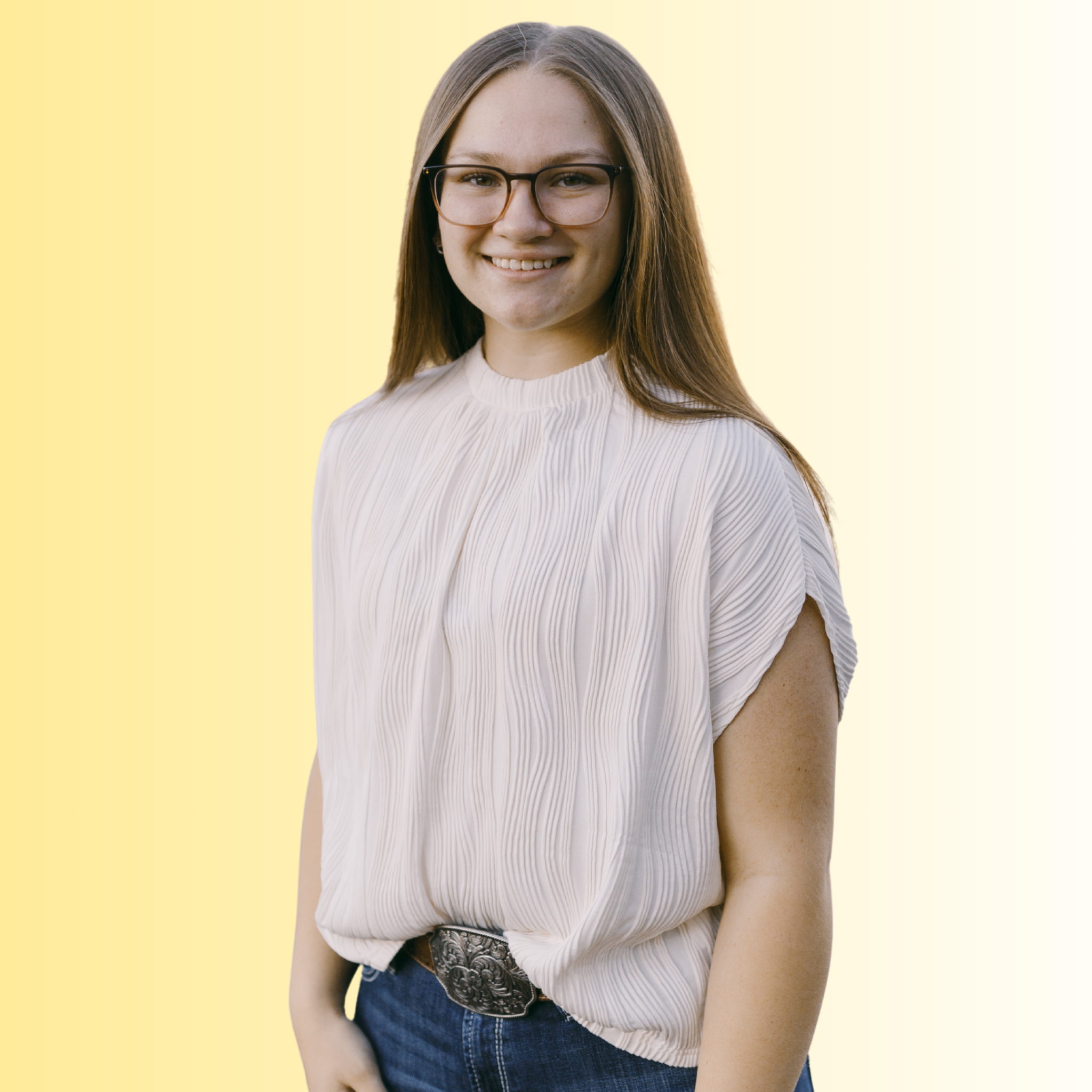 A young woman with long brown hair, glasses, and a white pleated blouse smiling against a green background.