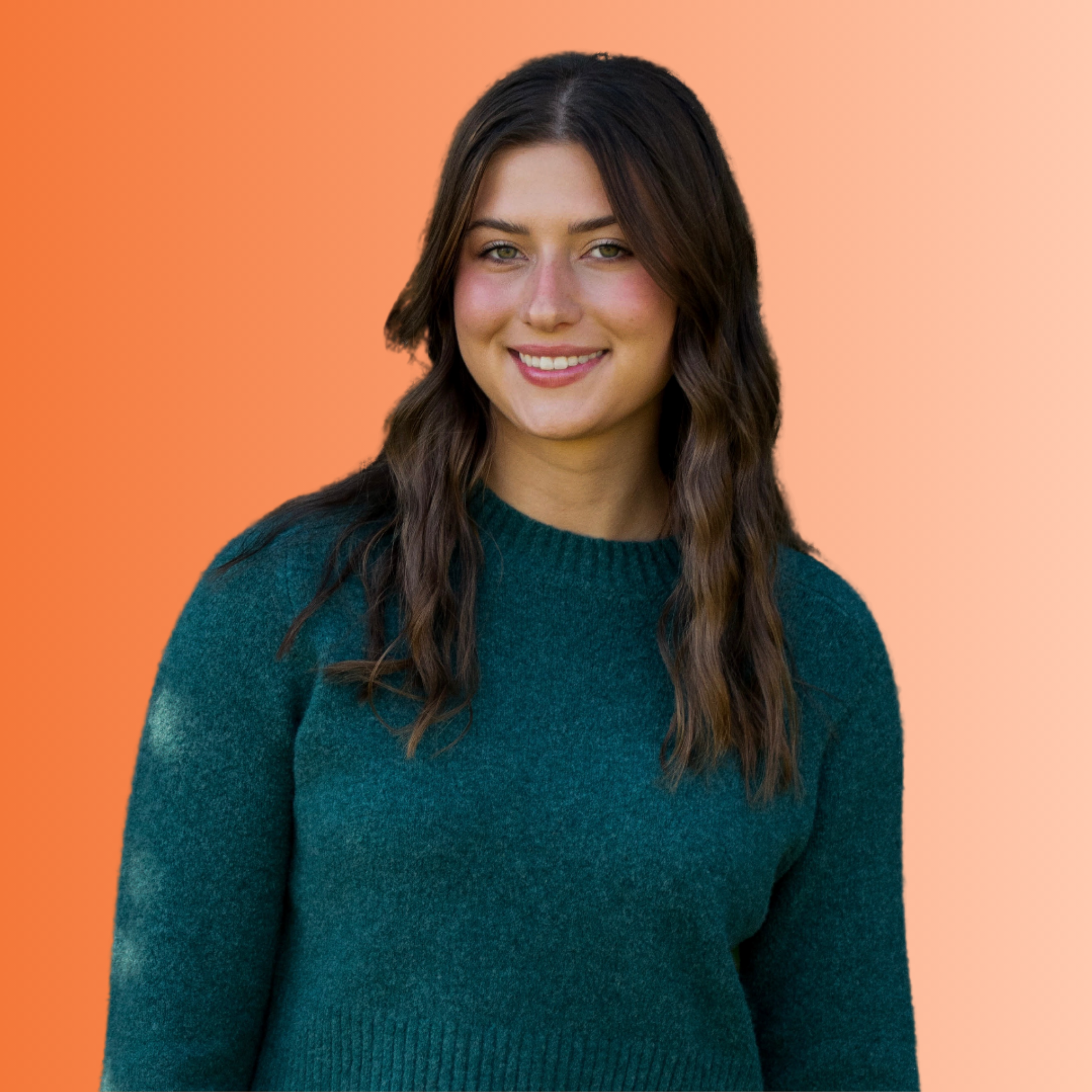 Portrait of a young woman with long wavy brown hair, wearing a teal sweater, smiling, against a gradient green background.