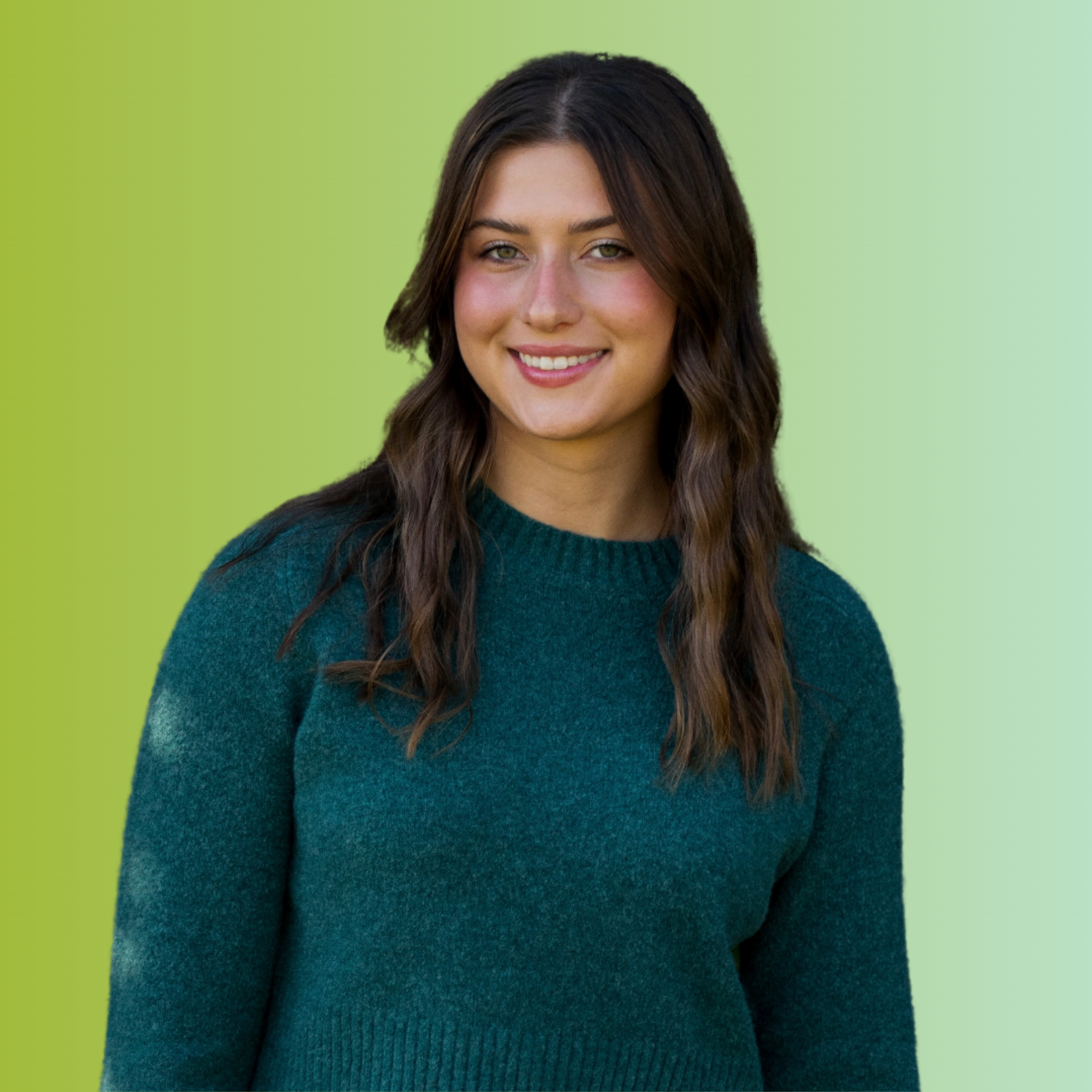 Portrait of a young woman with long wavy brown hair, wearing a teal sweater, smiling, against a gradient green background.