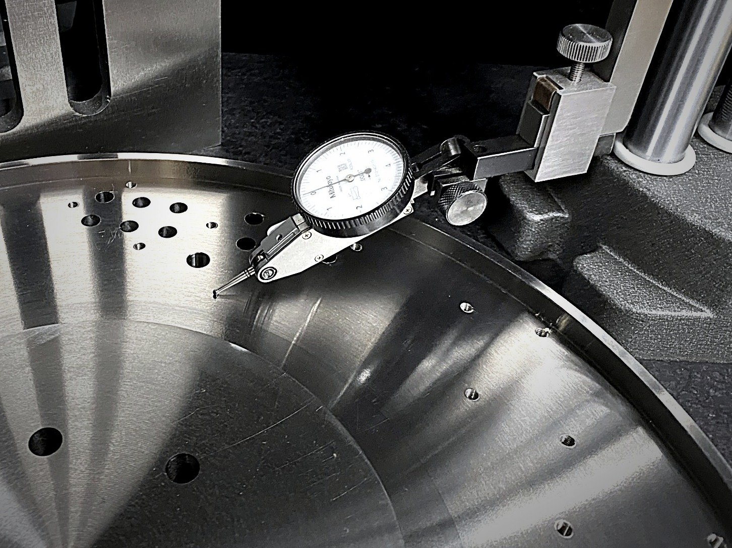 Dial test indicator checking a precision-machined stainless part