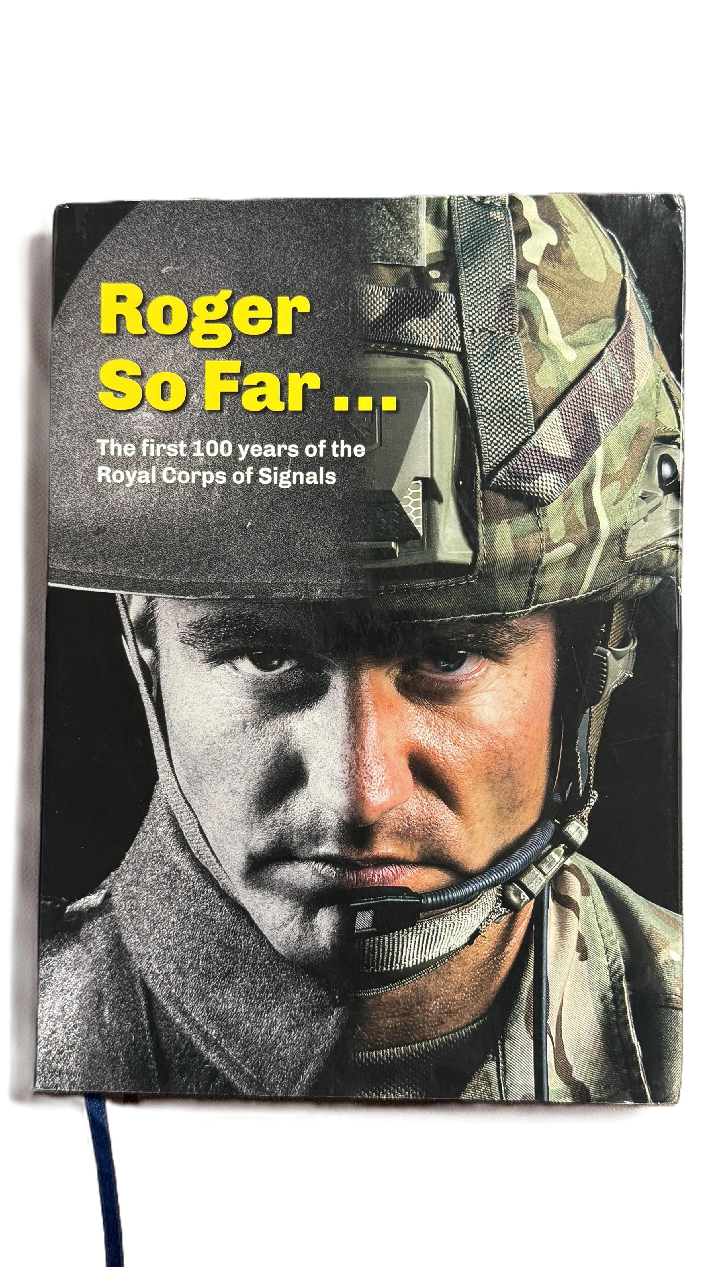 Book cover titled "Roger So Far... The first 100 years of the Royal Corps of Signals" featuring a soldier in camouflage helmet with a stern expression.