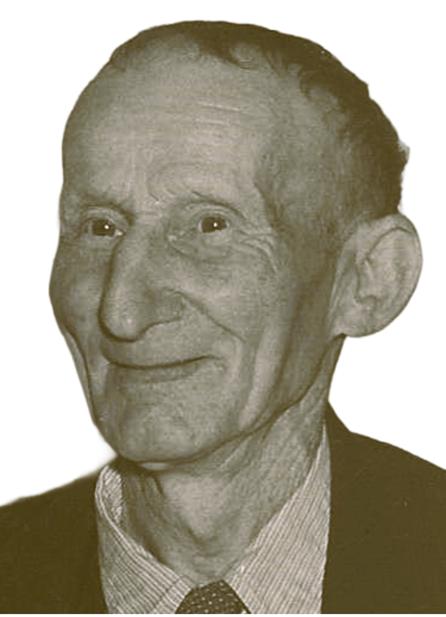 Black and white portrait of an elderly man with a large nose, broad smile, wearing a suit, shirt, and patterned tie.