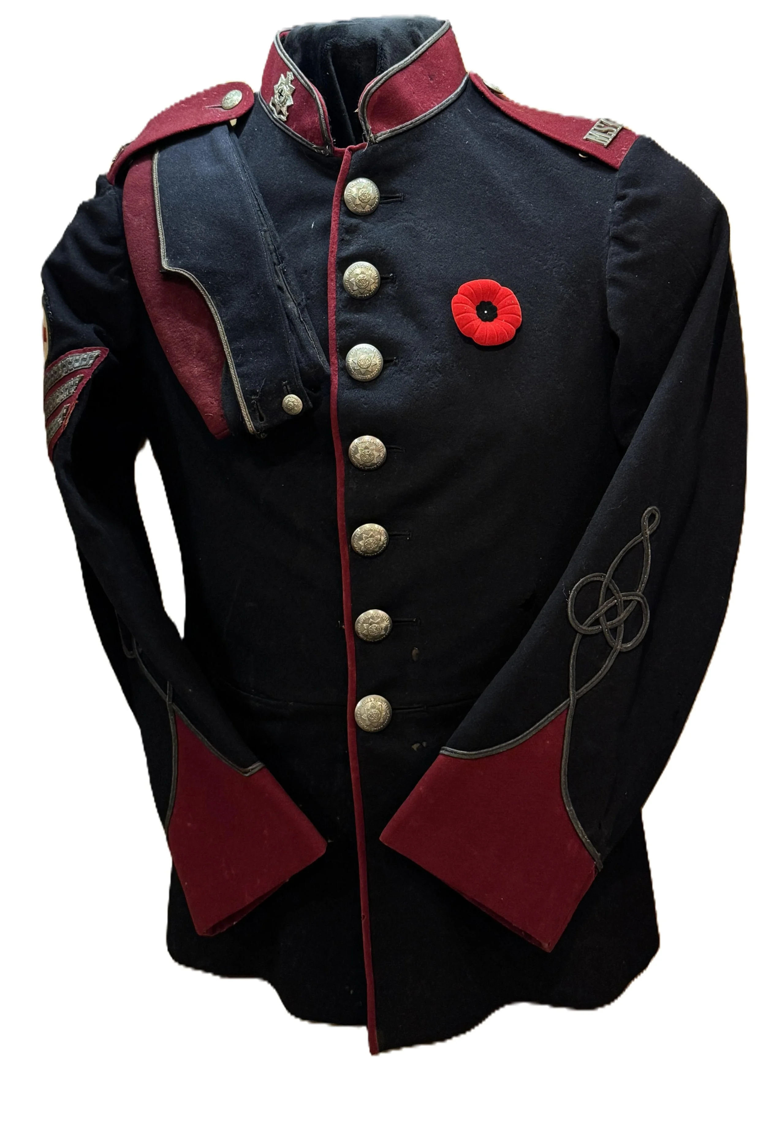 Military dress uniform jacket with red and black colors, adorned with brass buttons, a red poppy pin, and decorative embroidery on the sleeve.