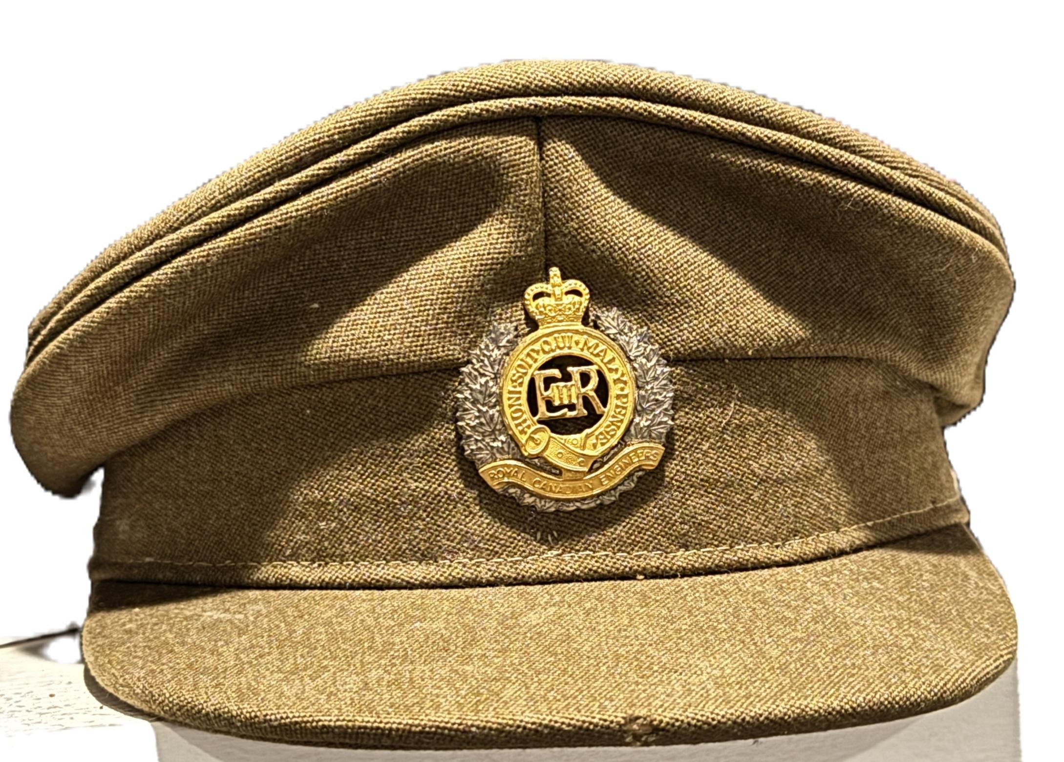 A vintage military cap with a Crown and badge on front reading 'Royal Canadian Navy'.