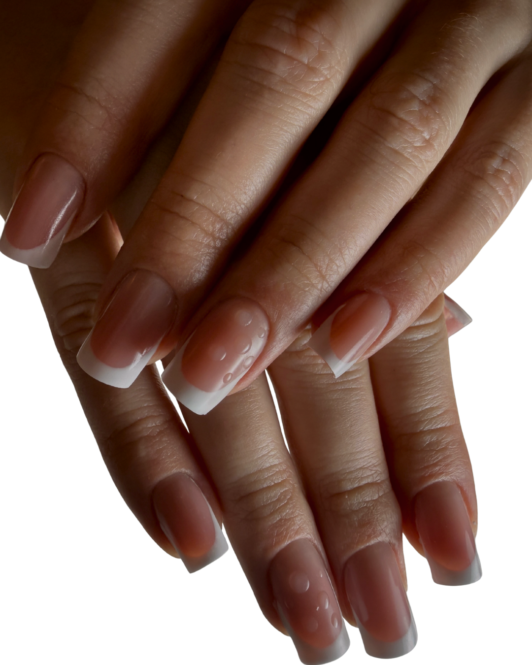 Close-up of a person's hands with Russian manicure nails featuring a classic French tip design, with a natural pink base and white tips.