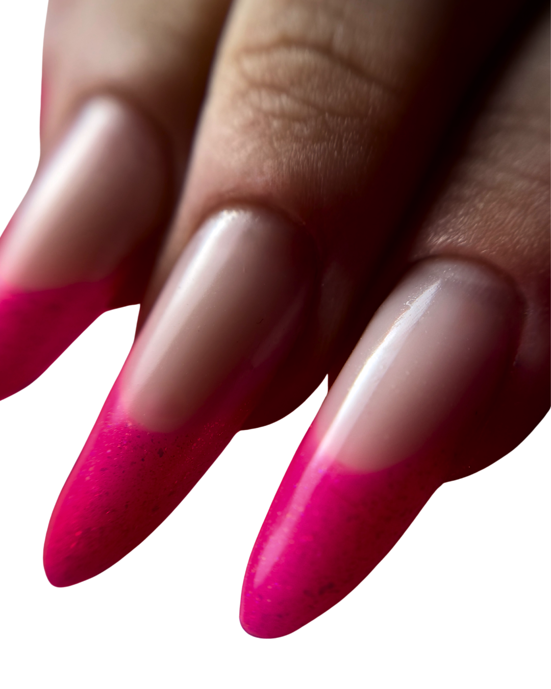 Close-up view of long, pointed nails with pink ombré French manicure.