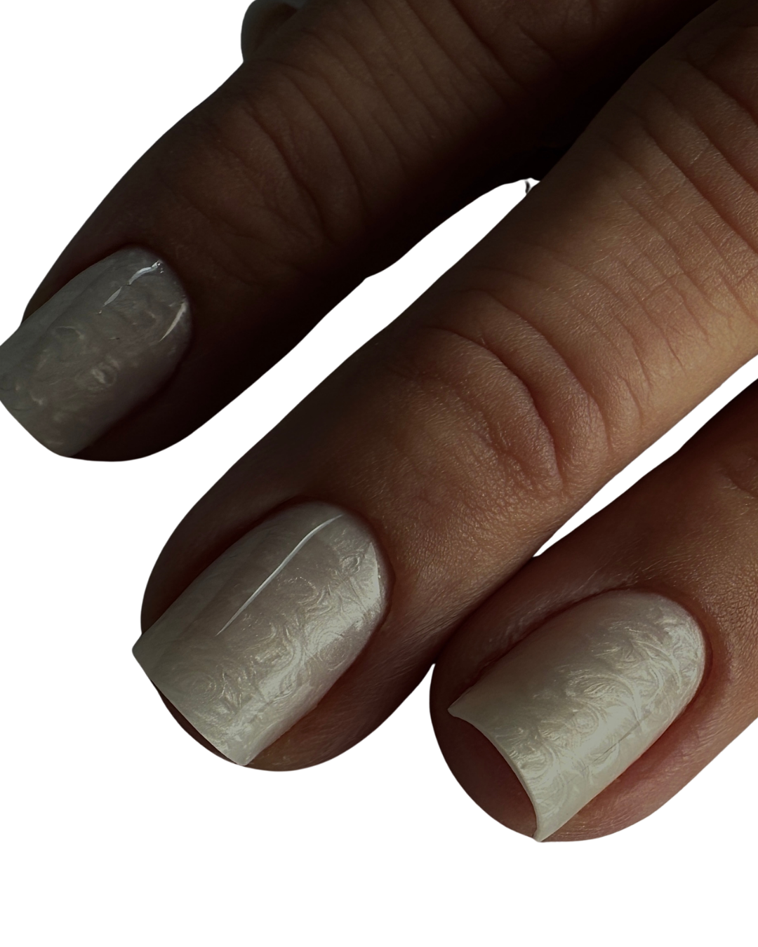 Close-up of a hand with Russian manicured nails painted in white with hand-painted nail art.
