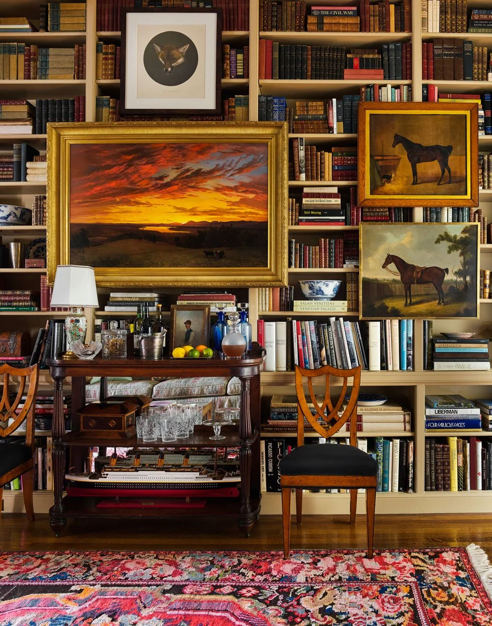 Astor-Courts-Book-shelf-covering-wall-with-overlaping-paintings.jpg