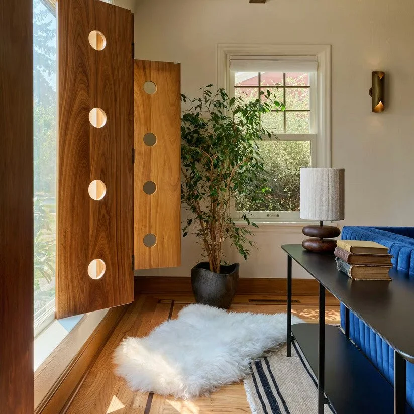 Erica Leader of @the.northwest.home details exactly how she refreshed the home of a Portland record store owner, including the playful custom wood shutters that open up the historic home, in @dwellmagazine The solid walnut and fun circular cutouts ma