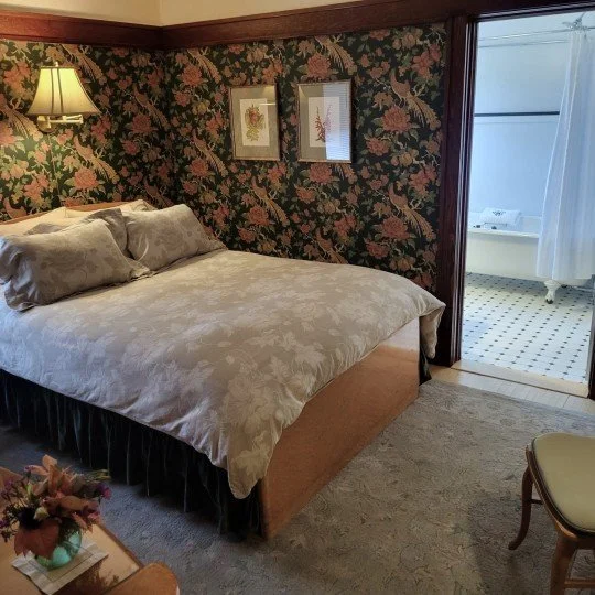 Period furnishings in a deluxe queen room.
