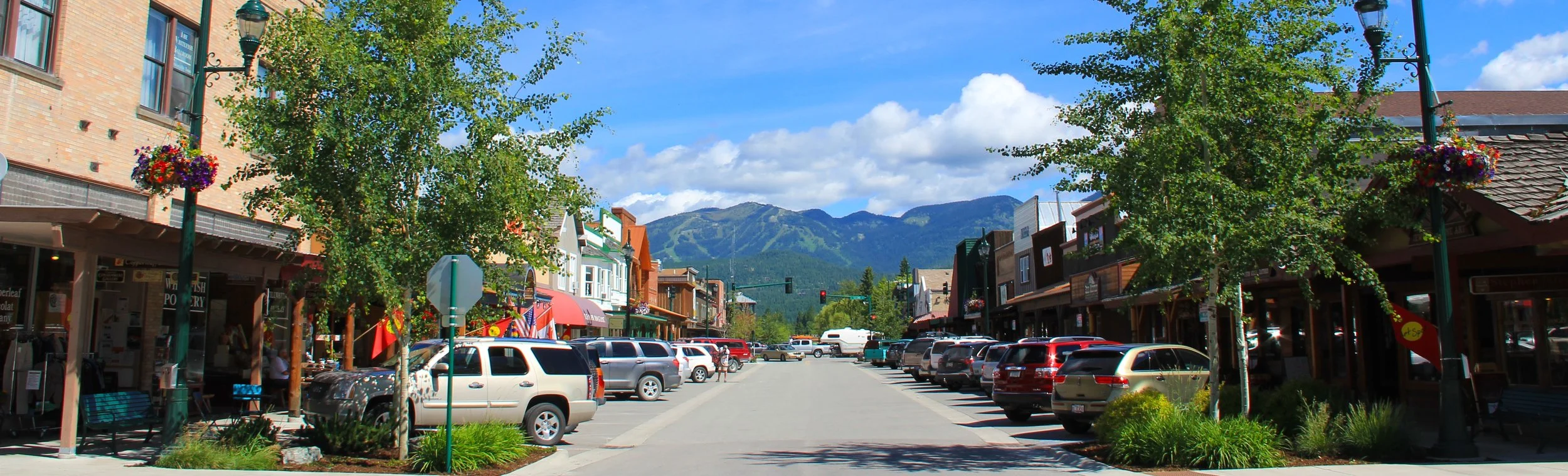 Whitefish's Central Avenue in summer with visitors and residents enjoying charming shops and award-winning restaurants one block from the Garden Wall Inn